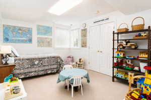 Carpeted room with a bed and double-door closet