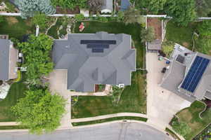 Expansive property featuring a multi-gabled roofline, solar panel array, and a concrete driveway