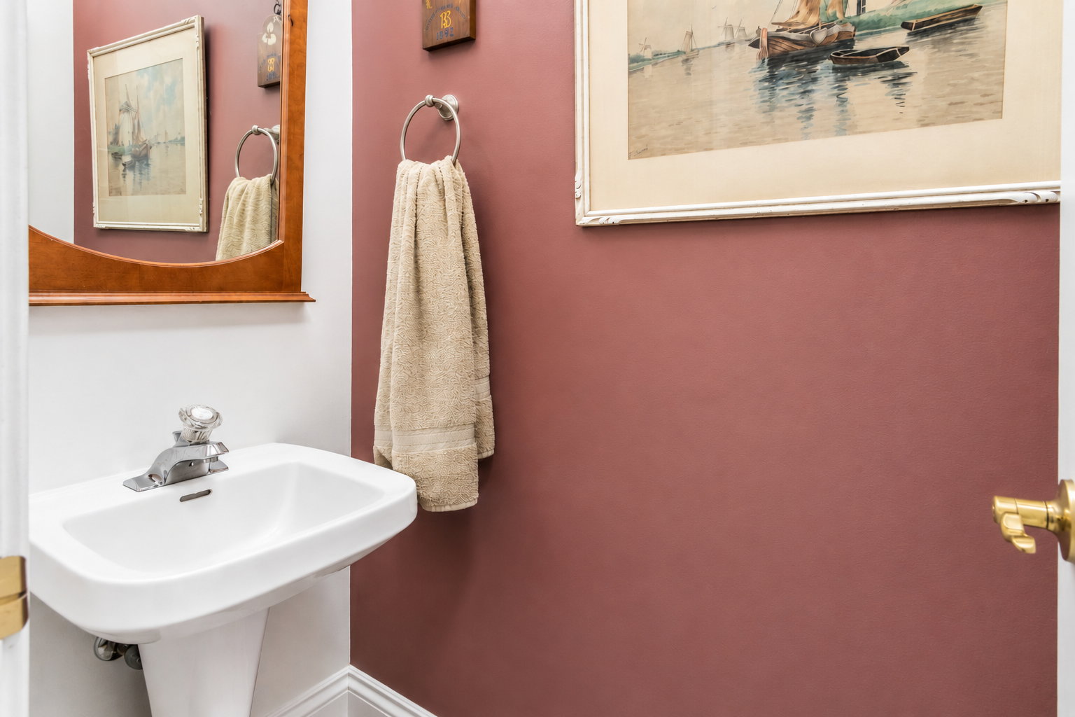 Pedestal sink with white ceramic basin and chrome faucet
