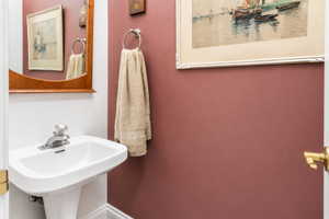 Pedestal sink with white ceramic basin and chrome faucet