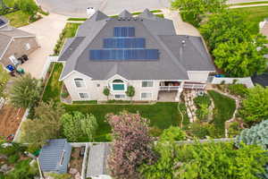 Two-story property featuring a multi-gabled roofline and multiple solar panel arrays