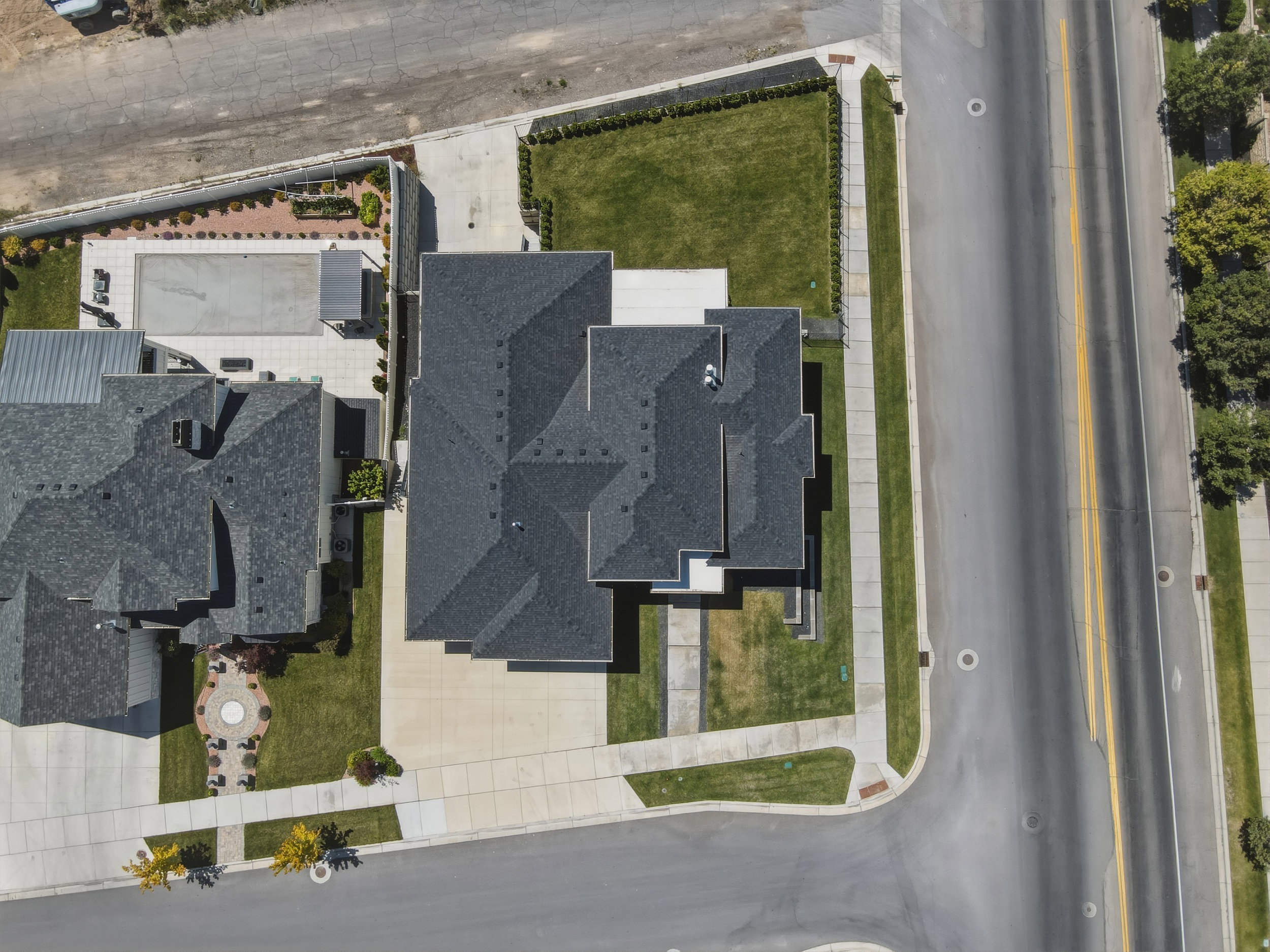 Aerial perspective showcasing a property with a multi-gabled roofline and dark shingle roofing