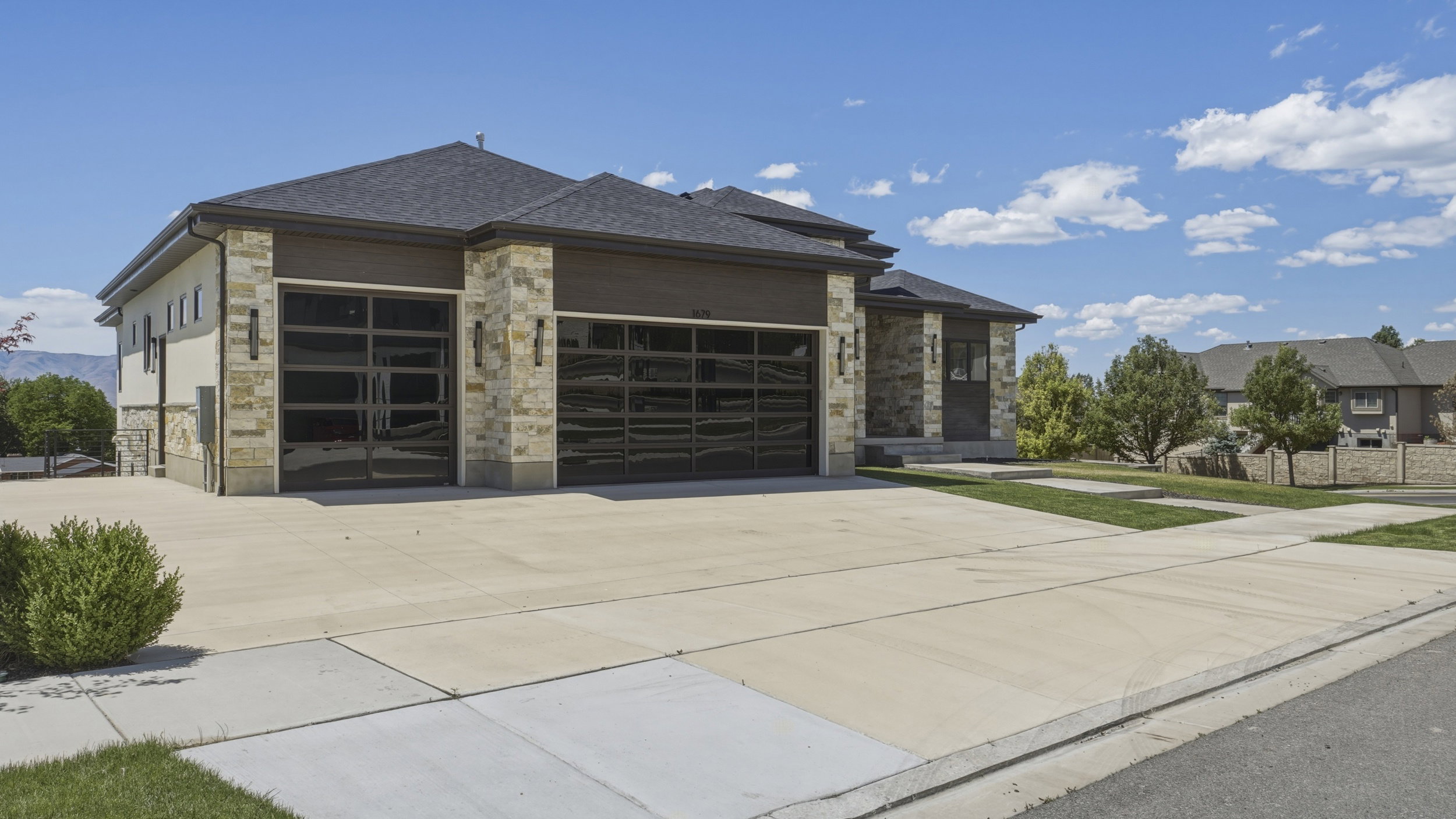 Contemporary exterior featuring stone accents and dark siding