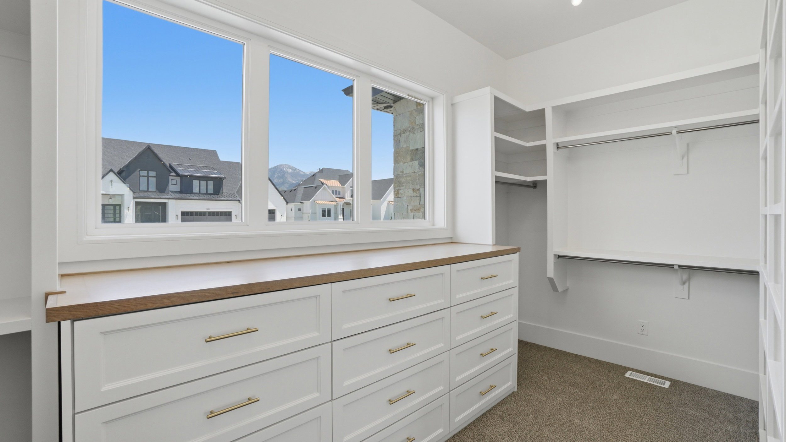 Custom built-in cabinetry with gold-tone hardware and wood-finish countertop
