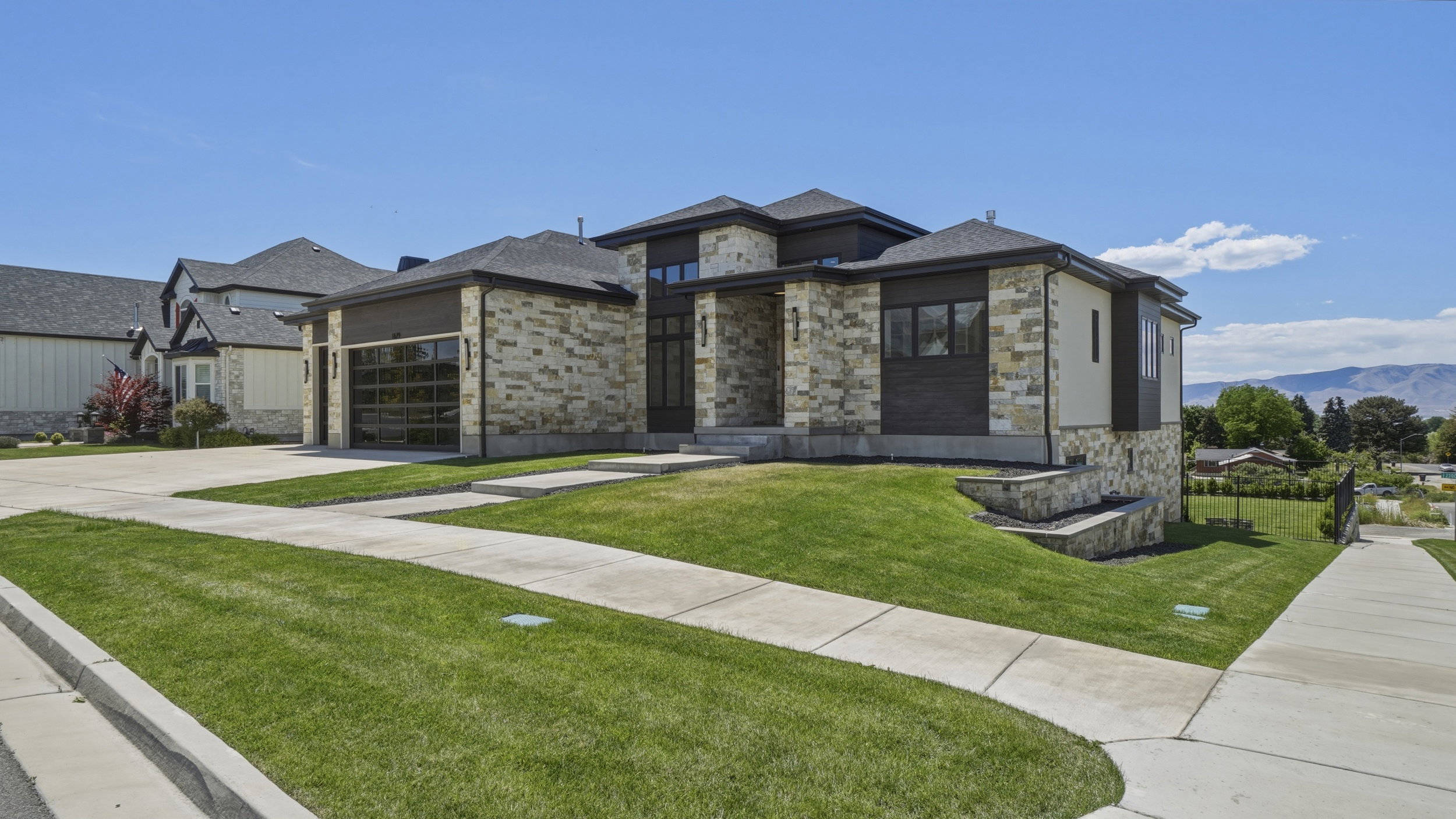 Contemporary residence featuring a stone and stucco facade