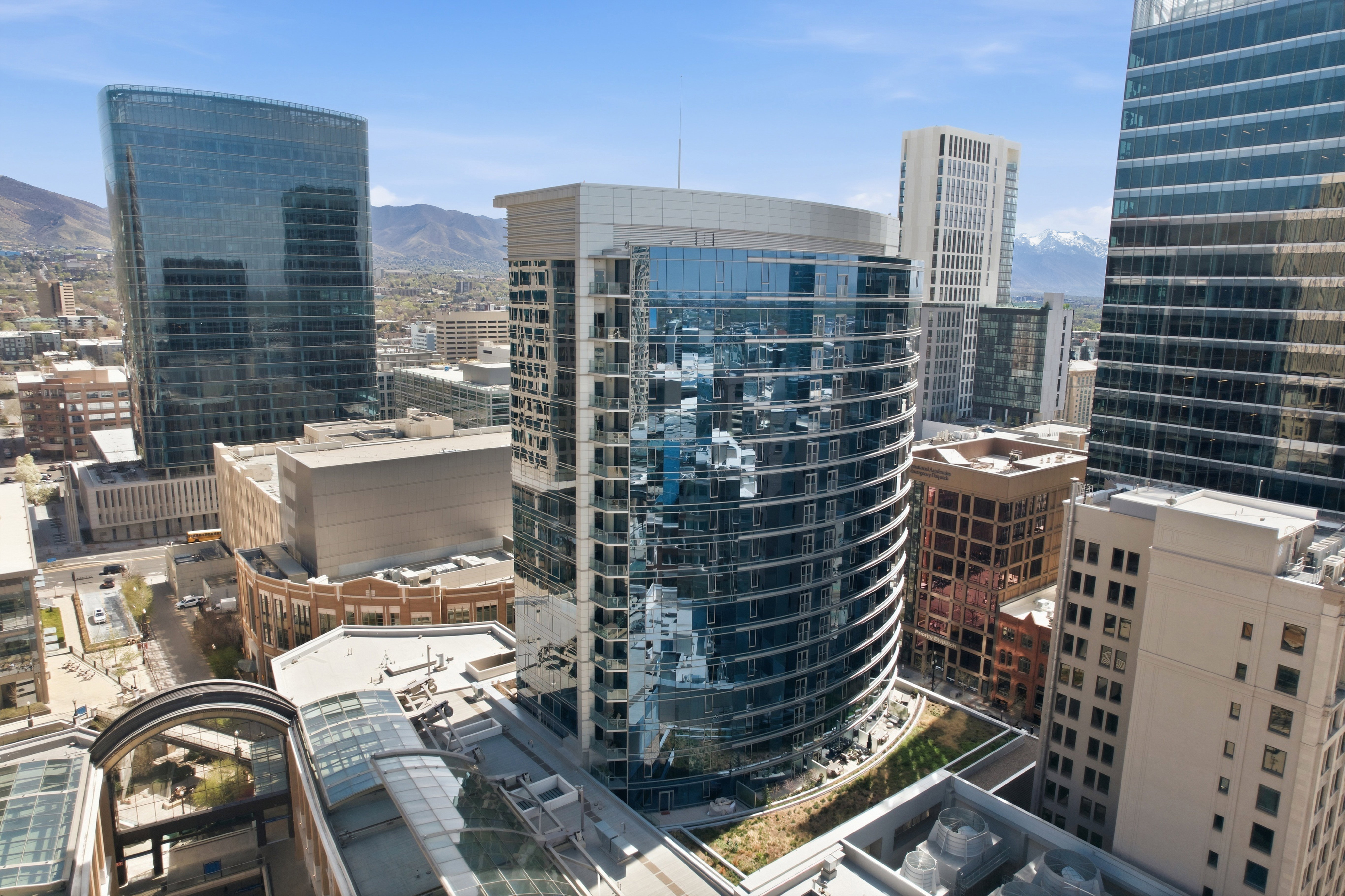 Modern high-rise with a curved glass facade and multiple floors