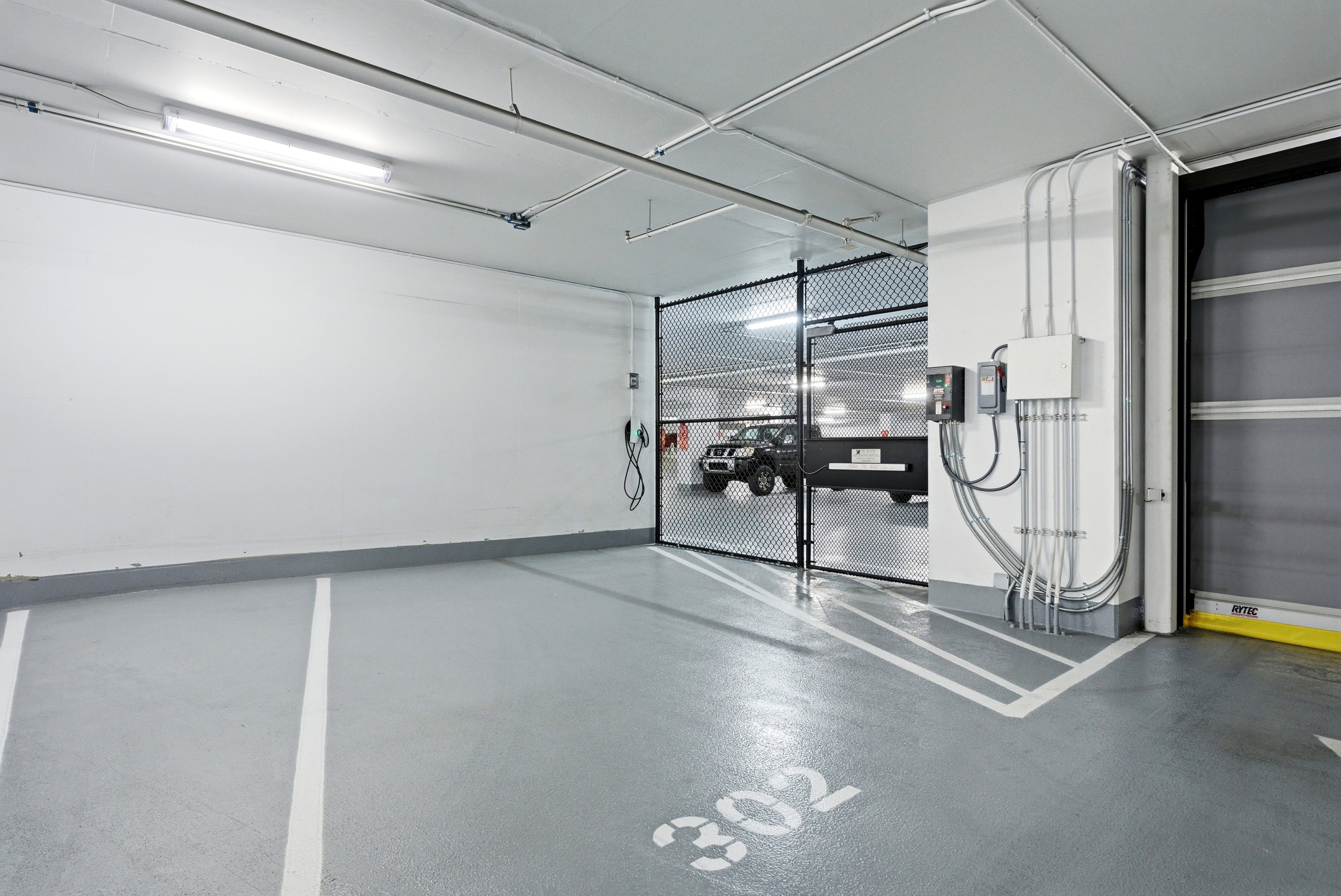 Private parking space 302 with a secured gate and EV charging station