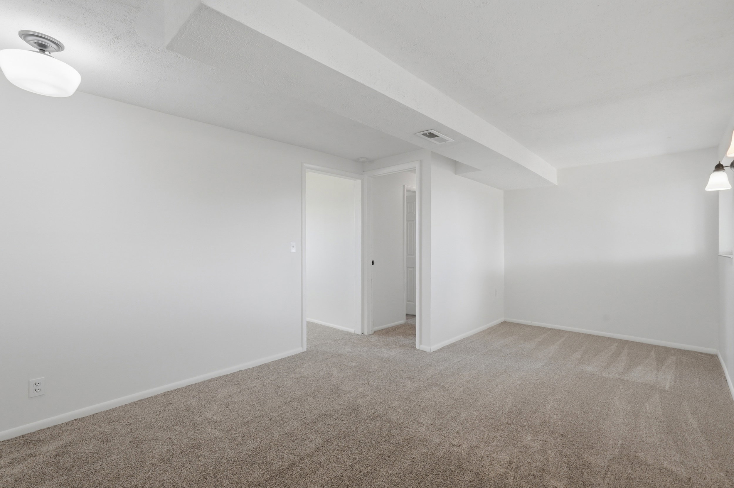 Neutral-toned wall-to-wall carpeting throughout this room