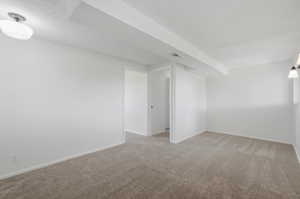 Neutral-toned wall-to-wall carpeting throughout this room