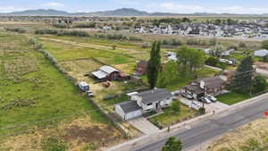 Expansive agricultural land featuring a red barn and secondary outbuilding