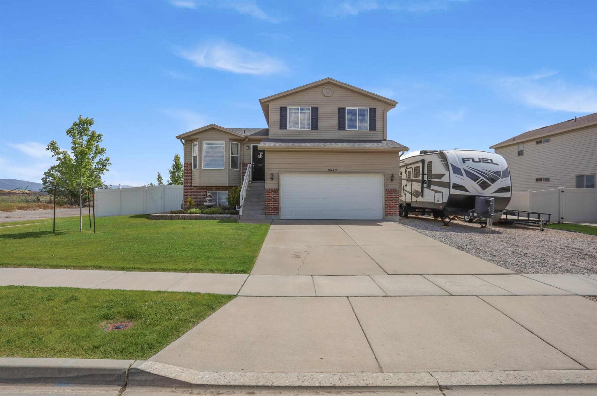 Front view of the home and the gravel RV pad