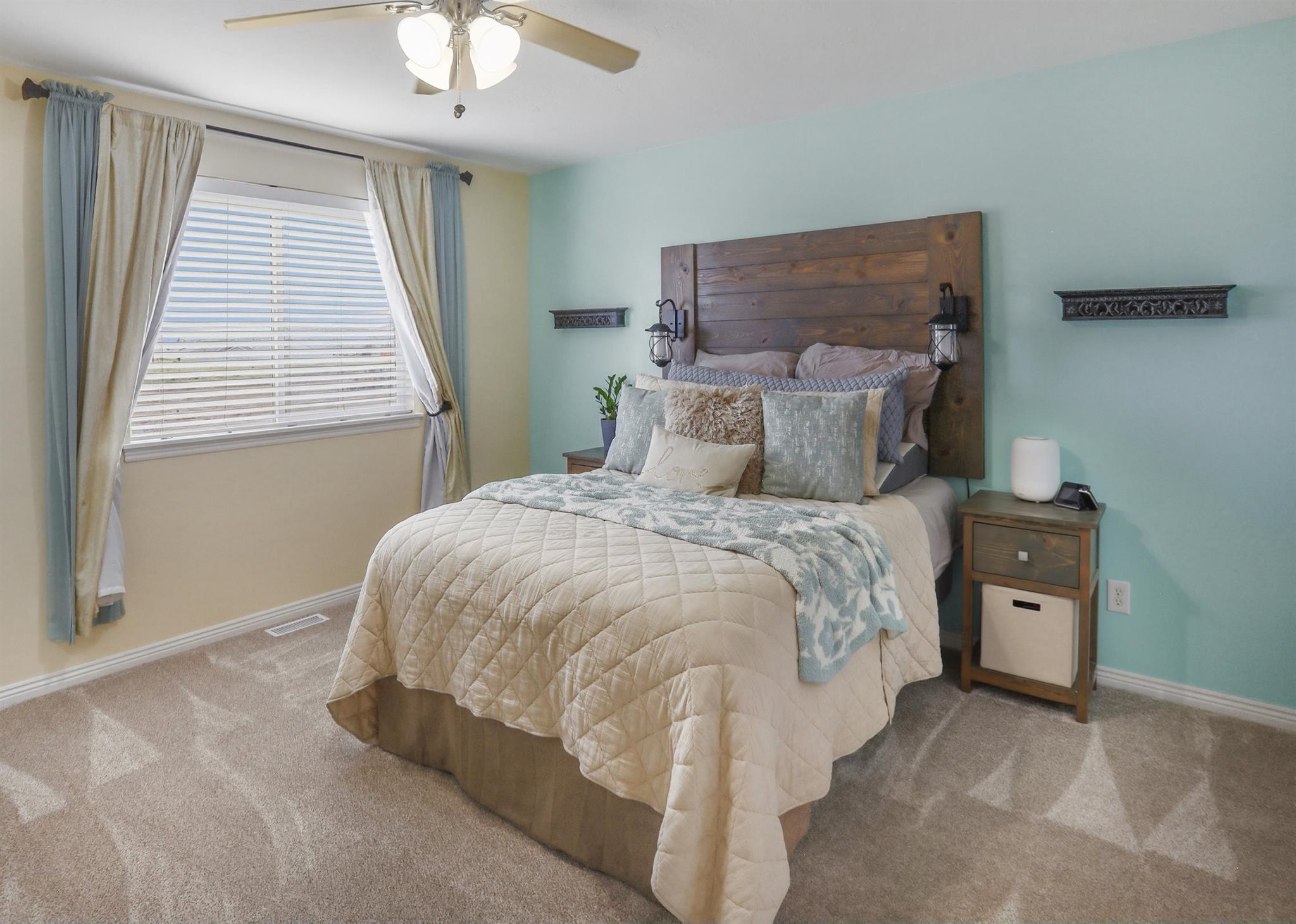 Primary Room featuring a large window with blinds, ceiling fan, and new carpet flooring