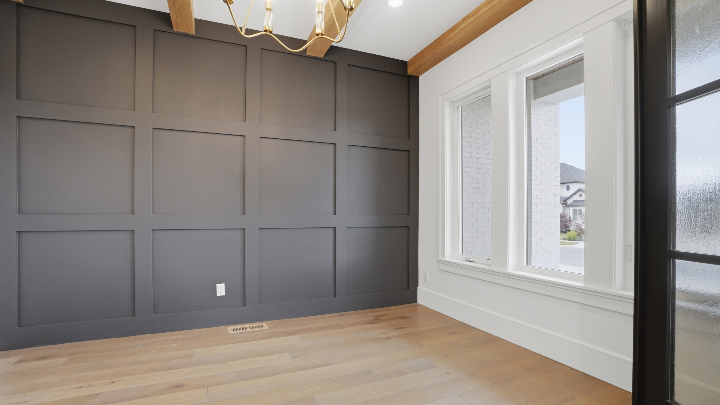 Accent wall featuring dark paneled wainscoting