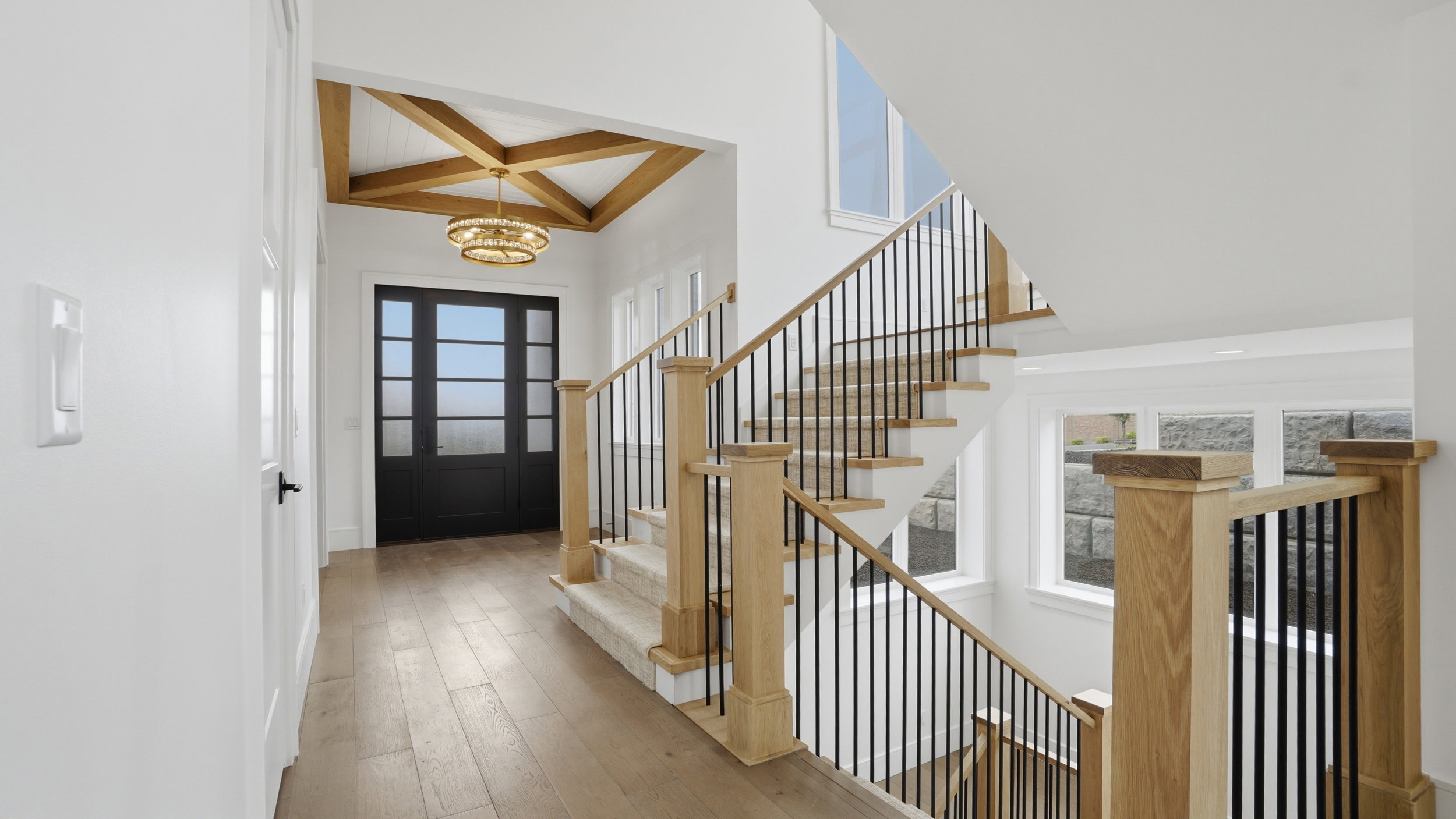 Entryway featuring wood-finish flooring and a coffered ceiling with exposed wood beams