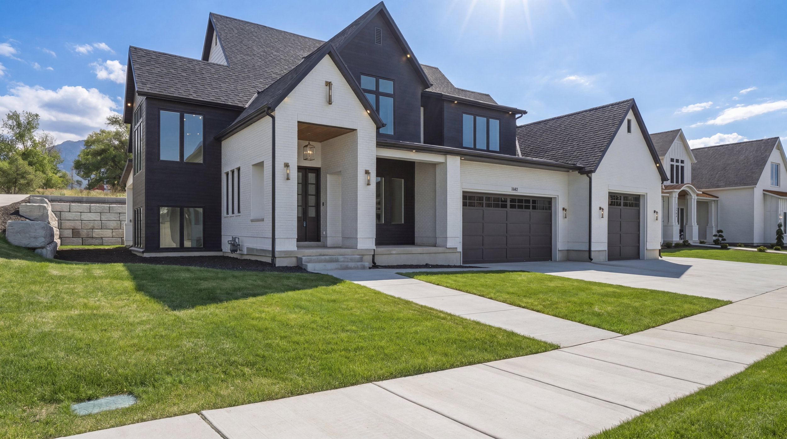 Modern two-story residence featuring a striking black and white exterior with diverse textures