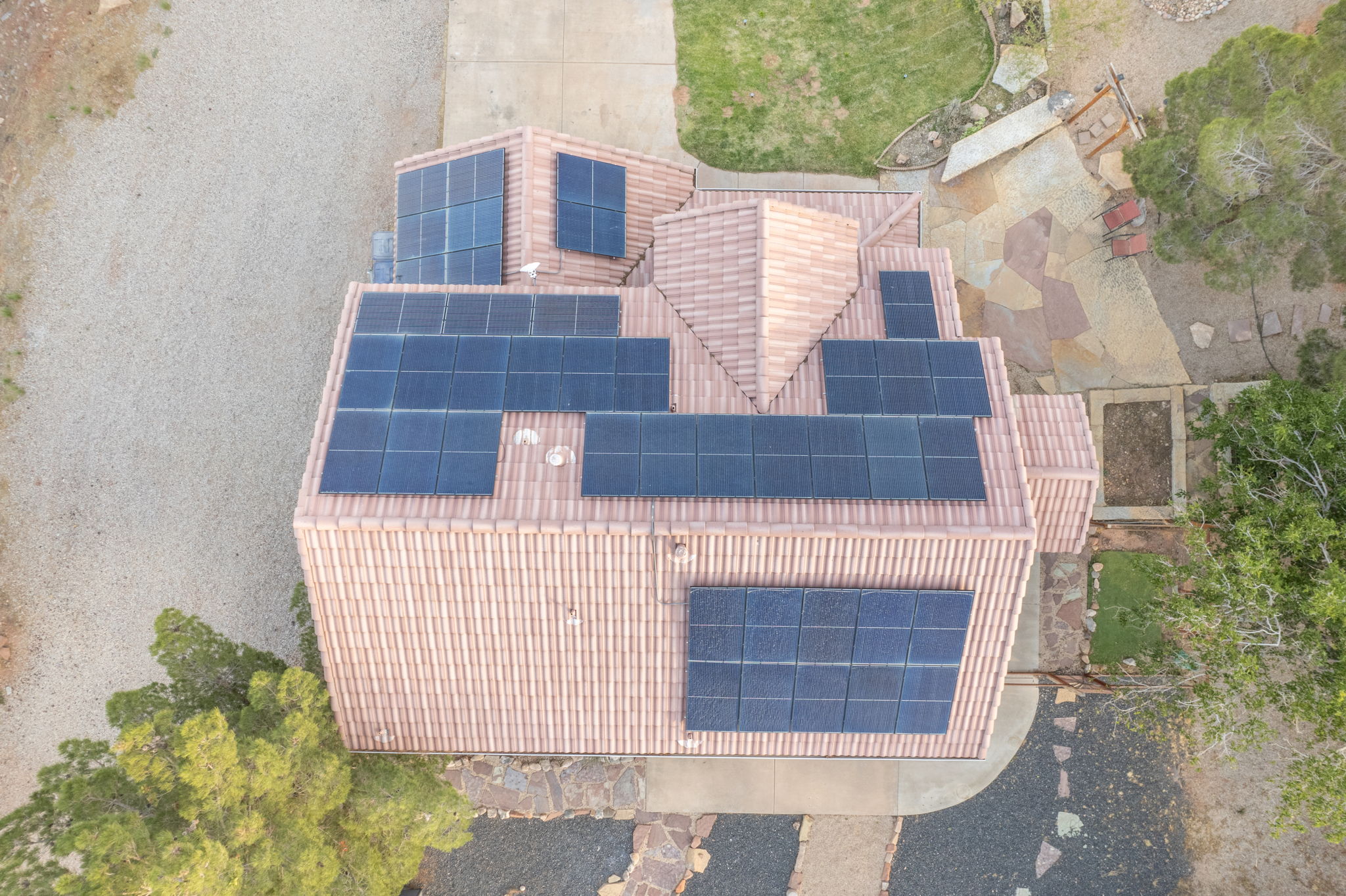 Terracotta tile roof with multiple solar panel arrays