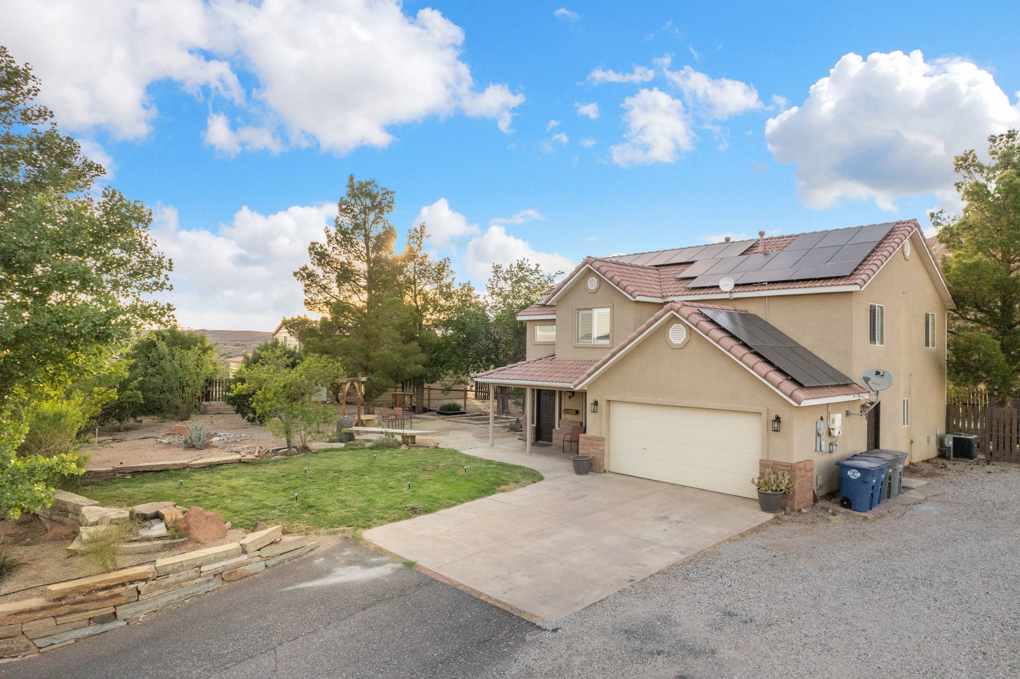 Two-story stucco residence featuring an attached garage and a tile roof