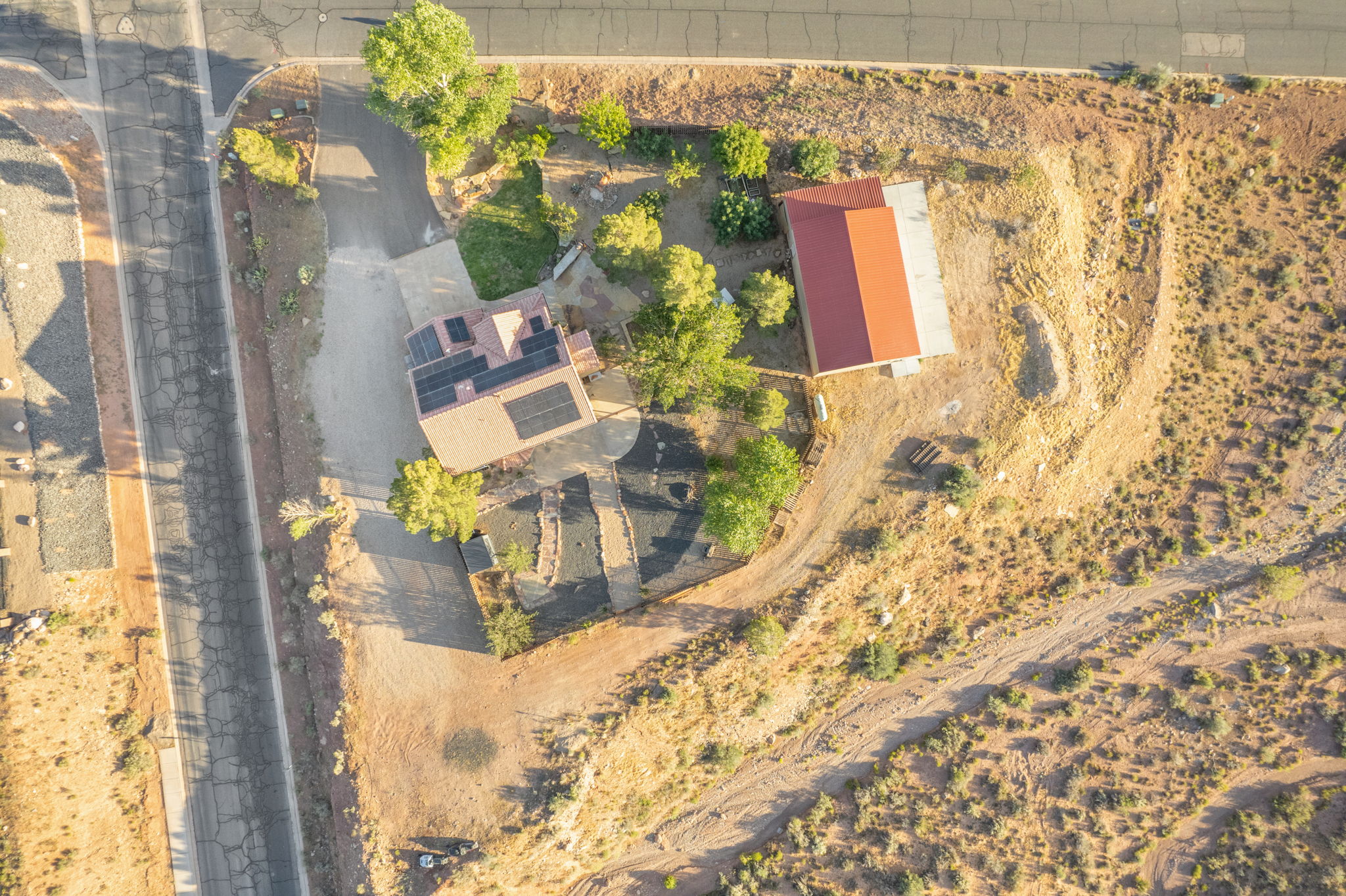 Aerial perspective showcasing a property with a main residence and a detached structure