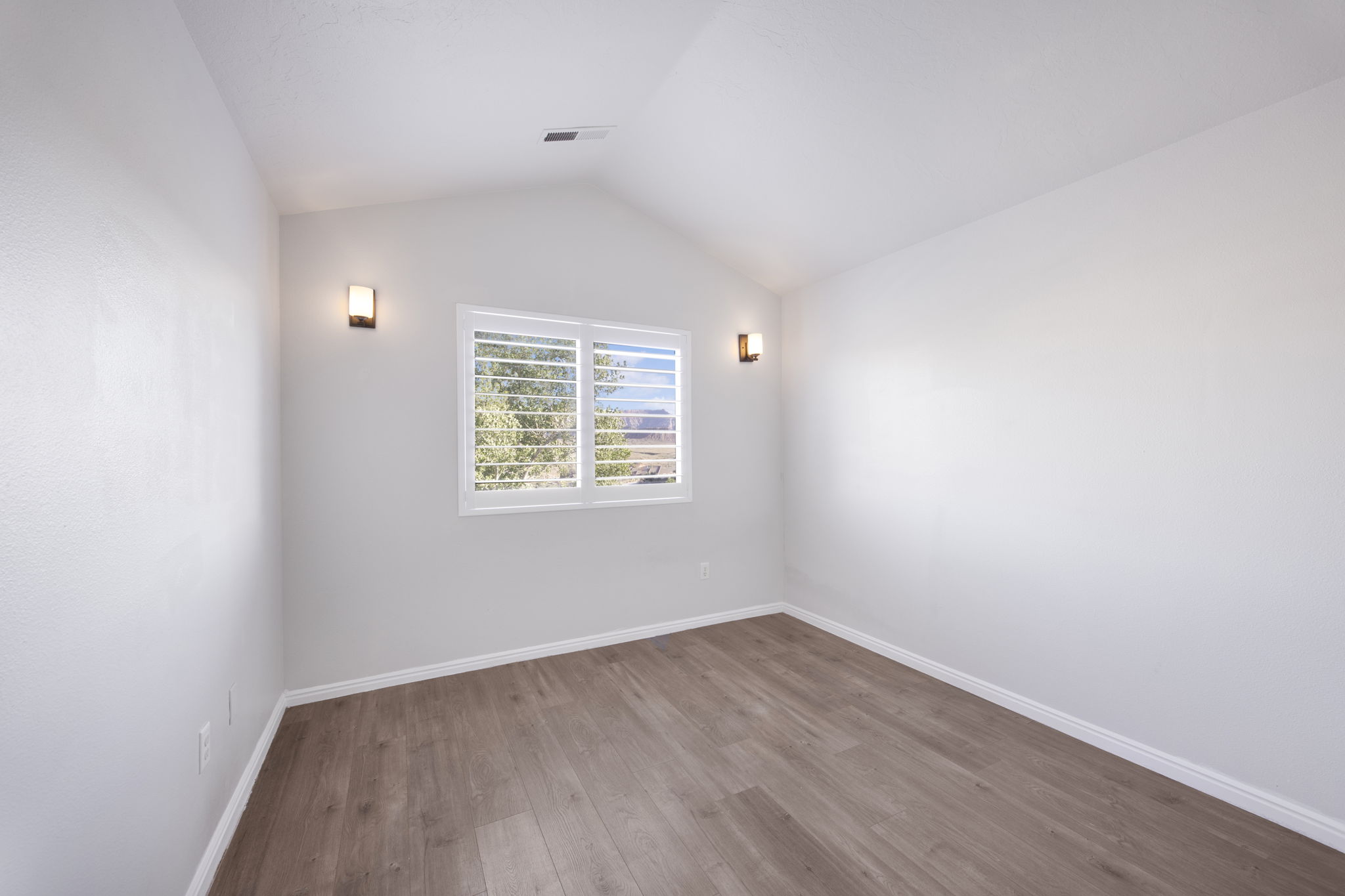 Vaulted ceilings complemented by wood-finish flooring