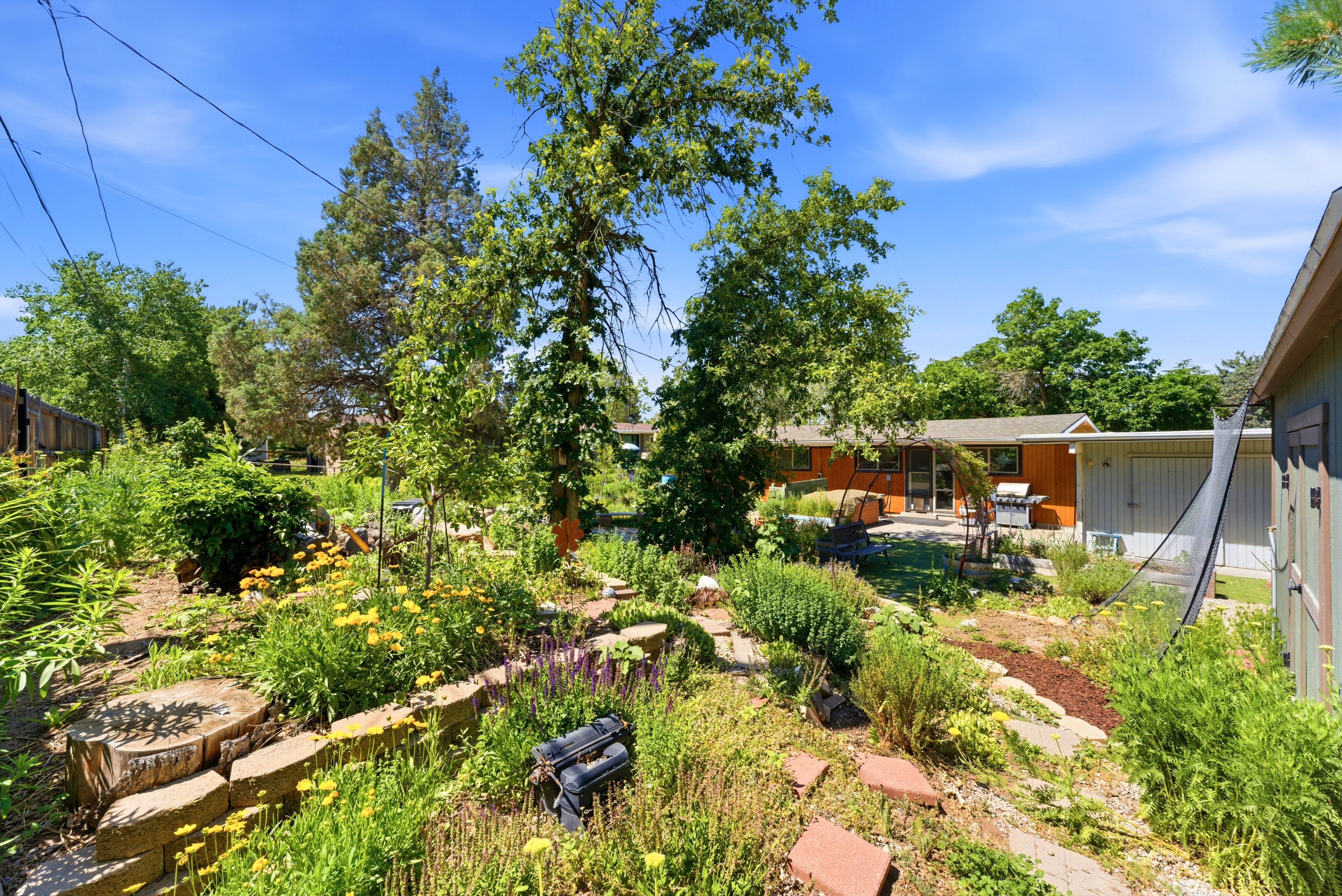 Tiered garden beds with stone retaining walls