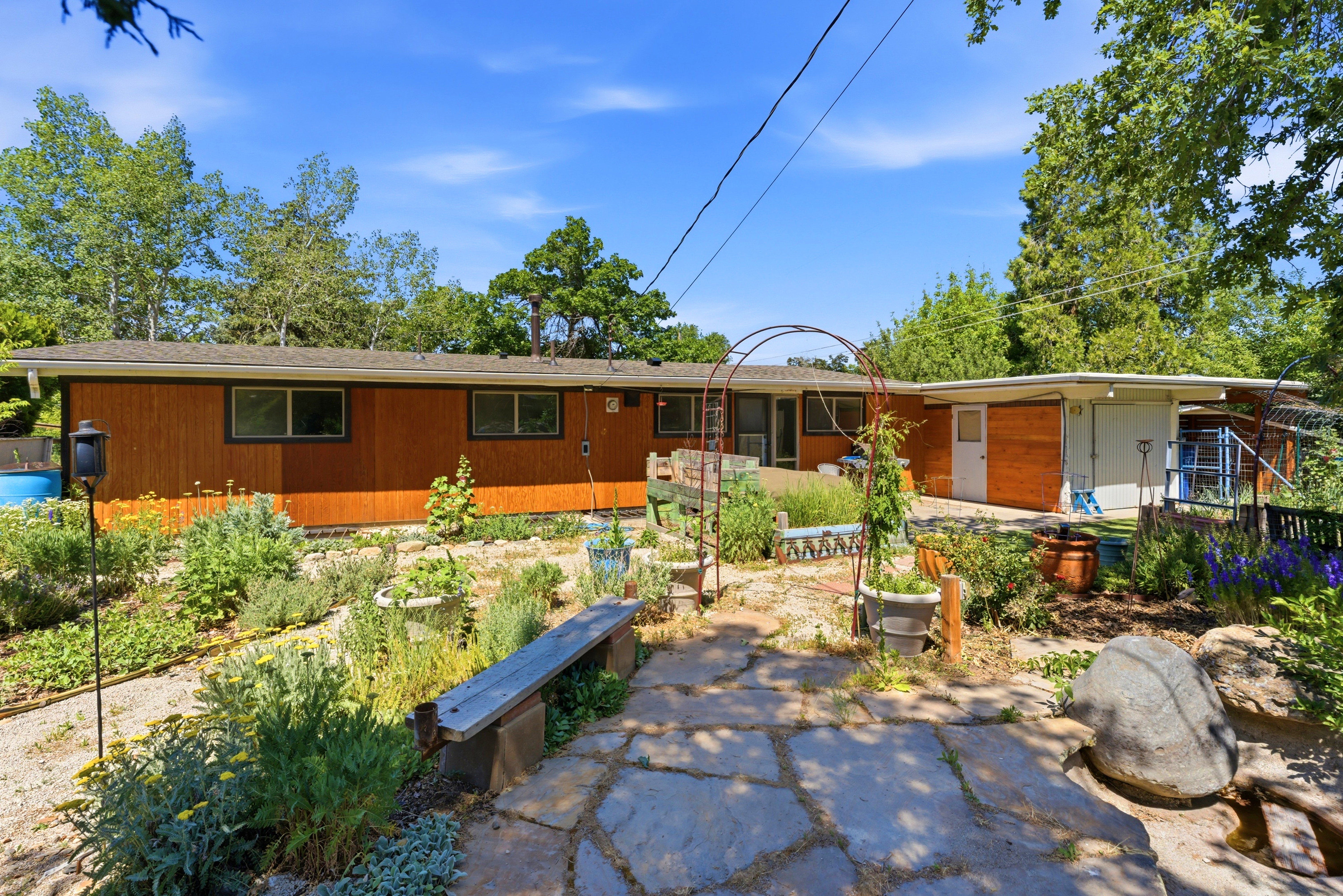 Rear exterior featuring wood siding and multiple windows