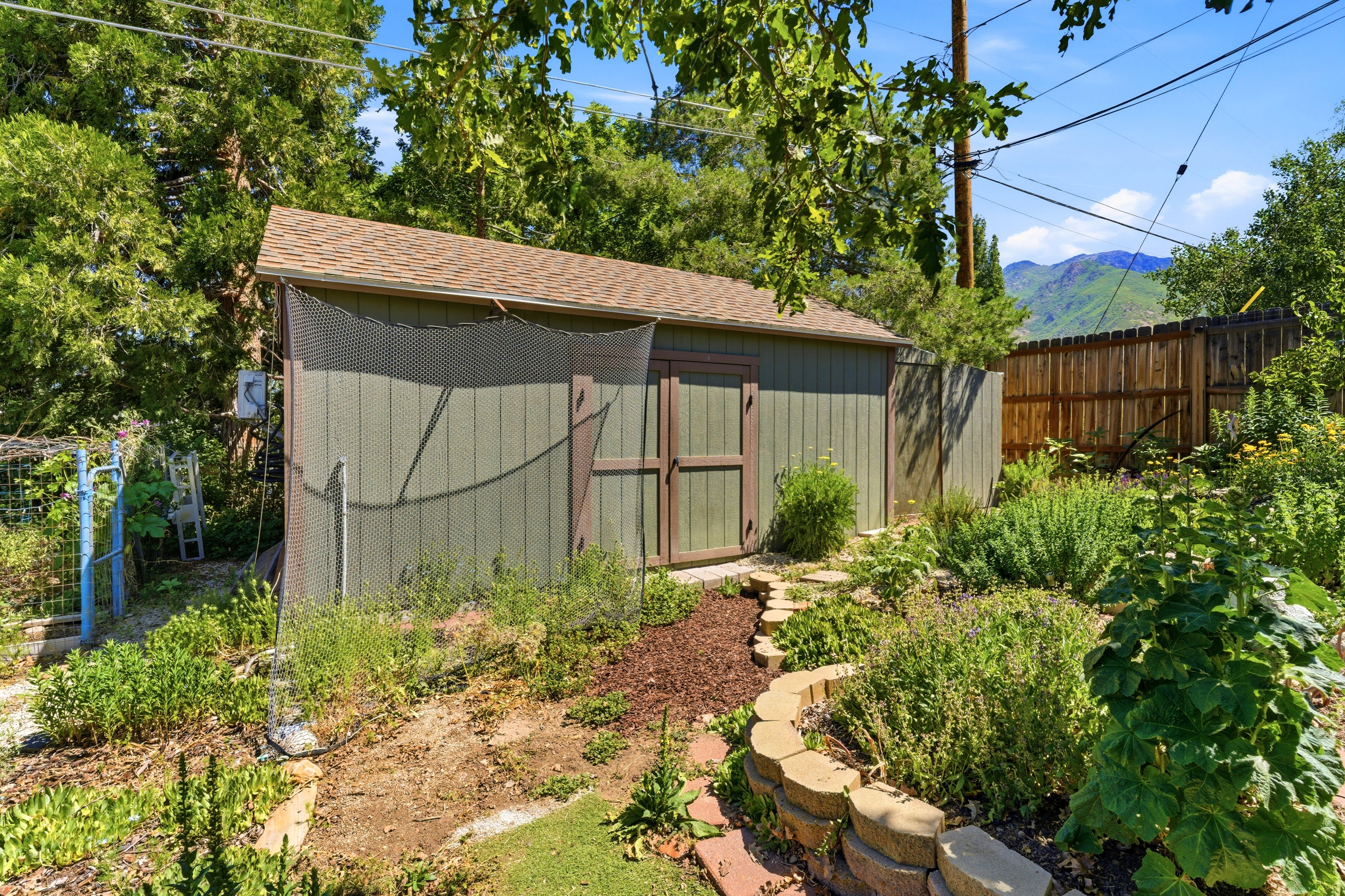 Spacious backyard shed with vertical siding and a shingled roof