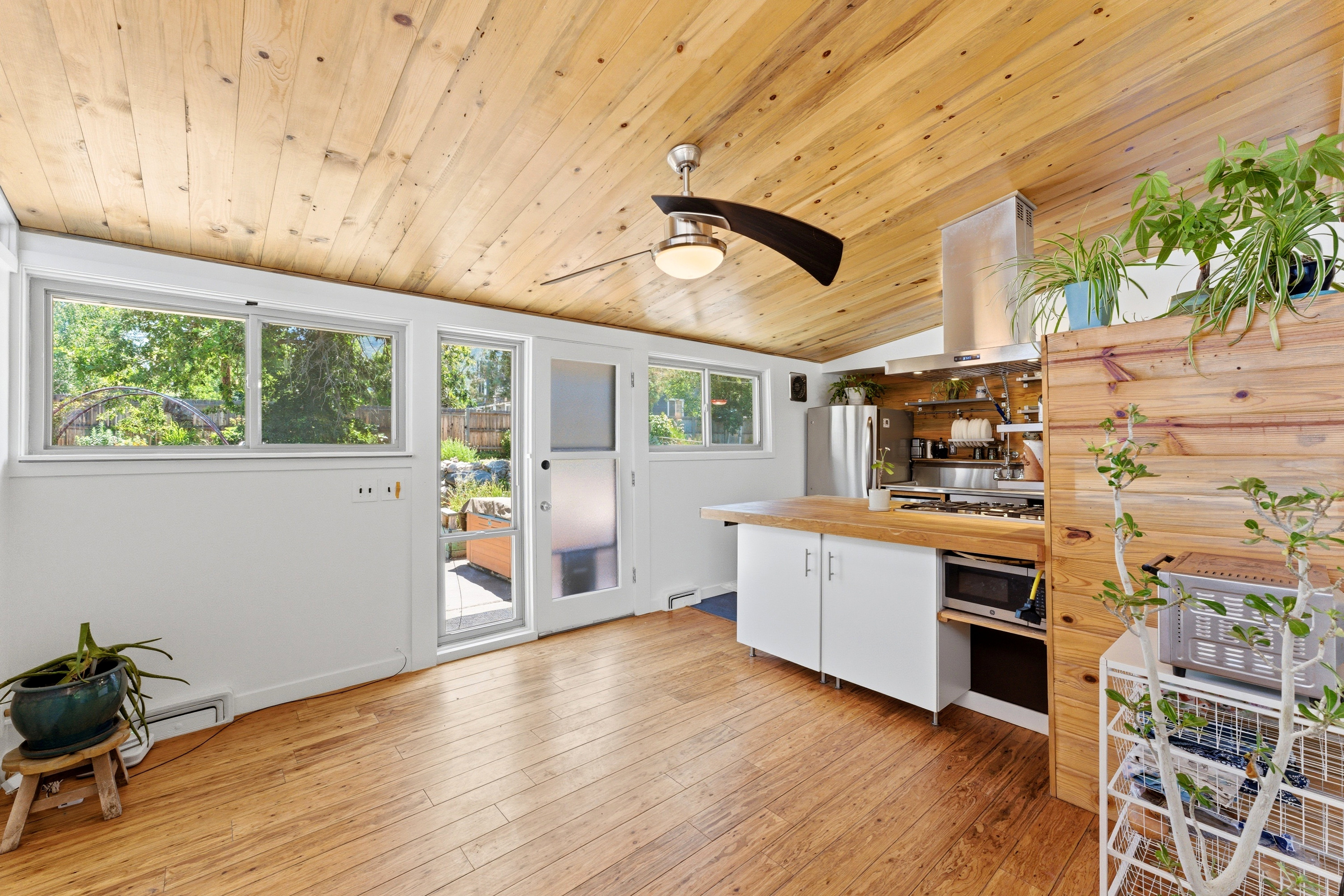 Vaulted wood-paneled ceiling with an overhead light fixture