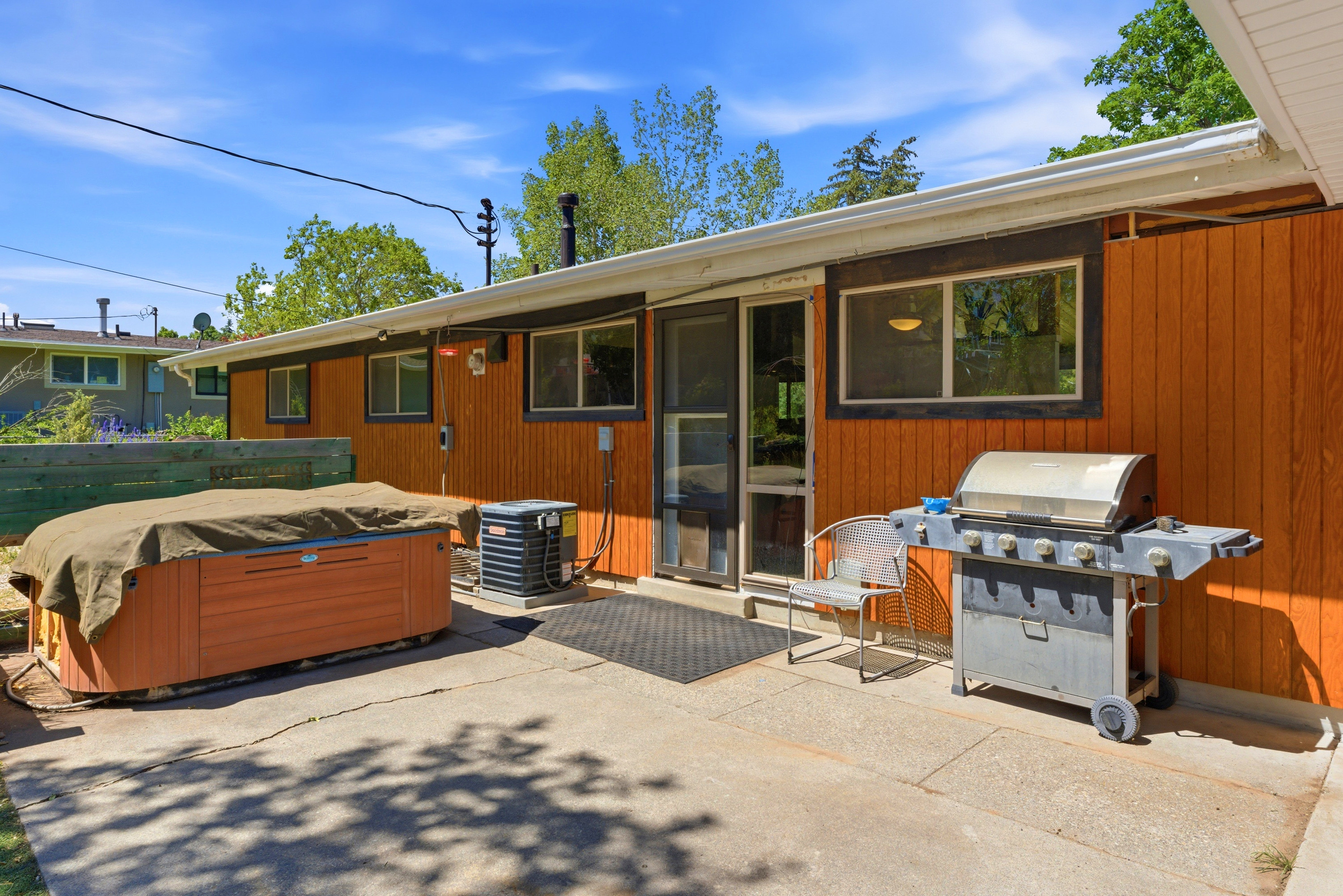 Outdoor patio area featuring concrete paving and a privacy fence