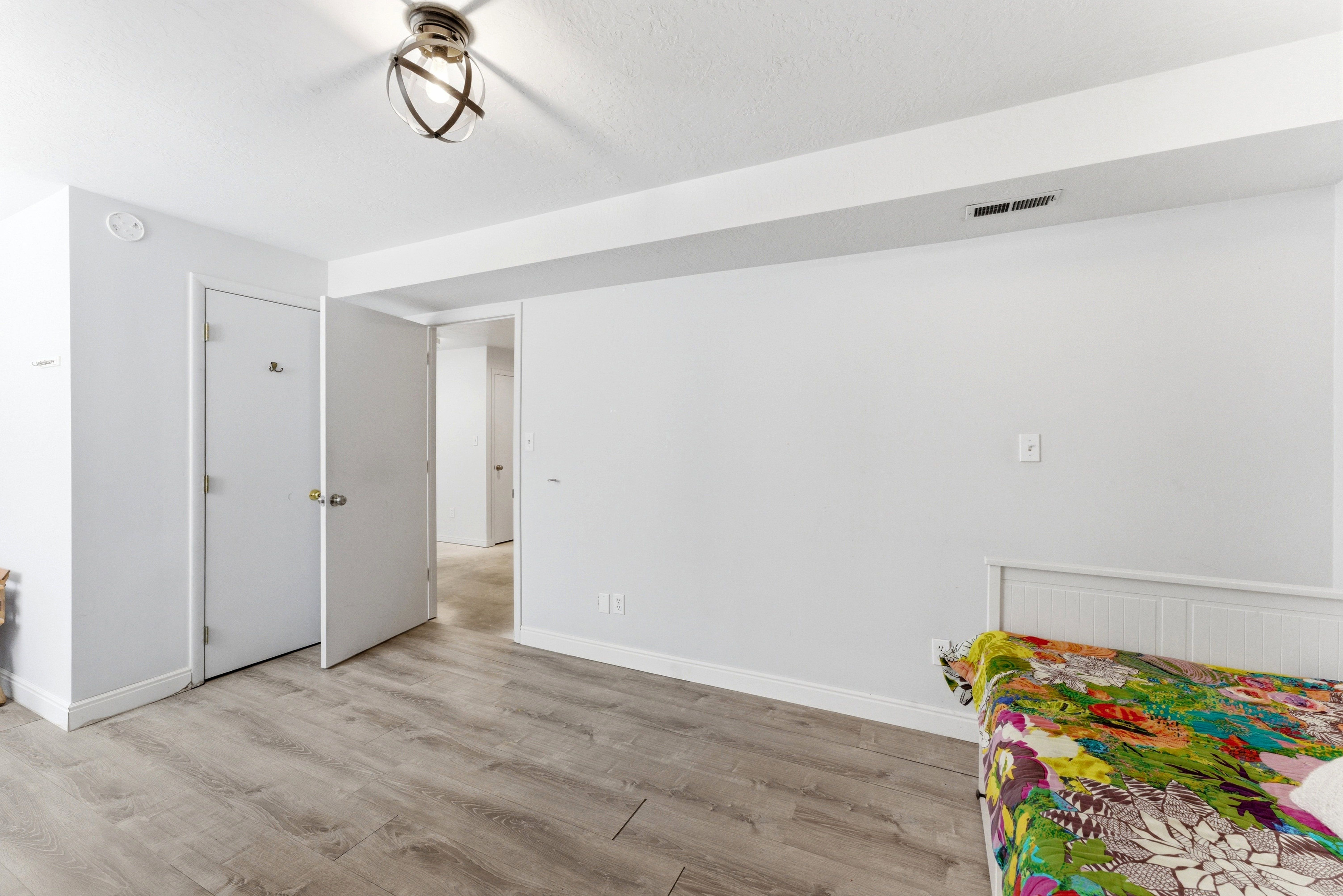 Interior room featuring wood-finish flooring, white baseboards, and a semi-flush mount ceiling light fixture