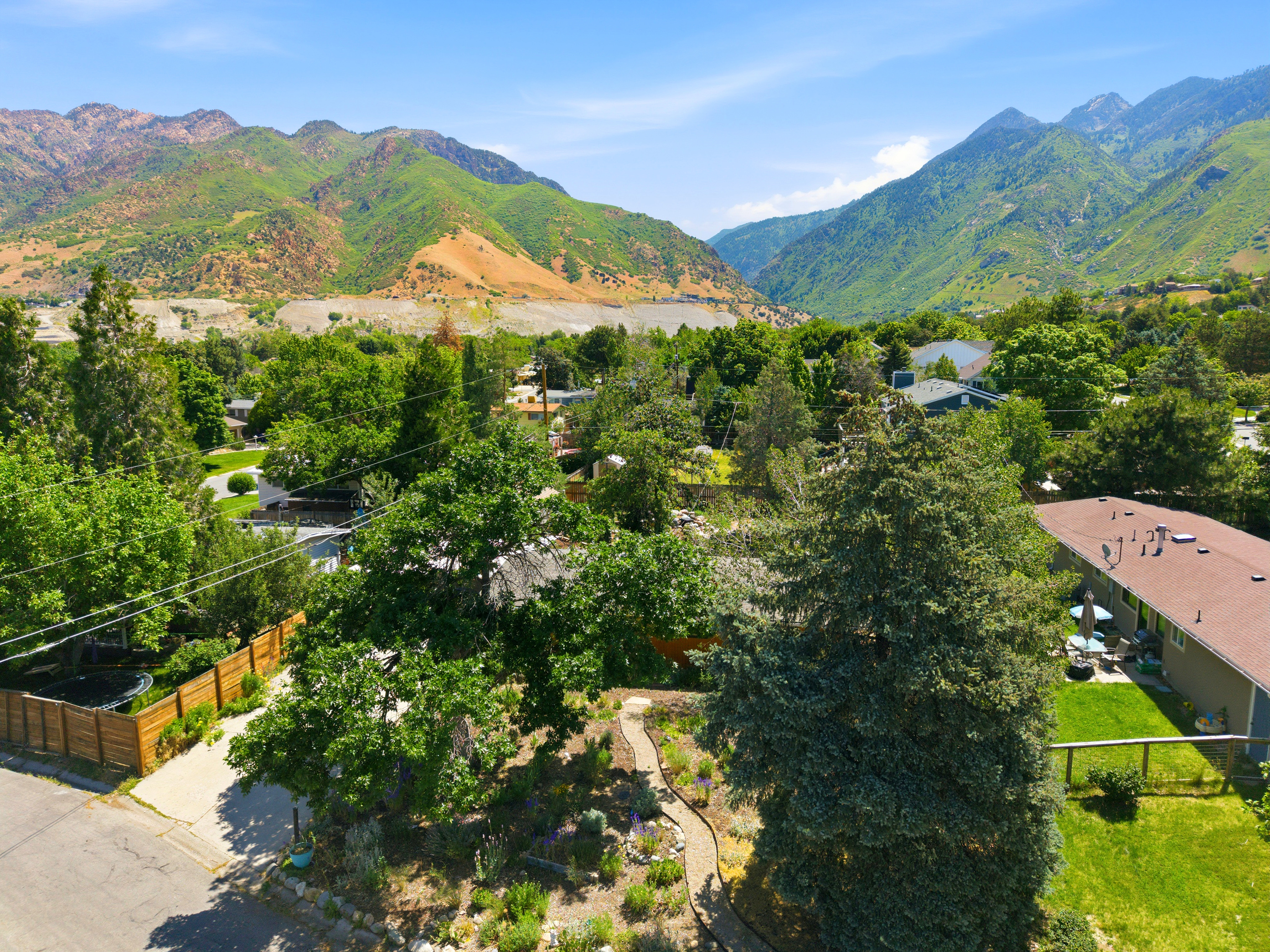 Expansive mountain backdrop featuring lush greenery and a clear blue sky