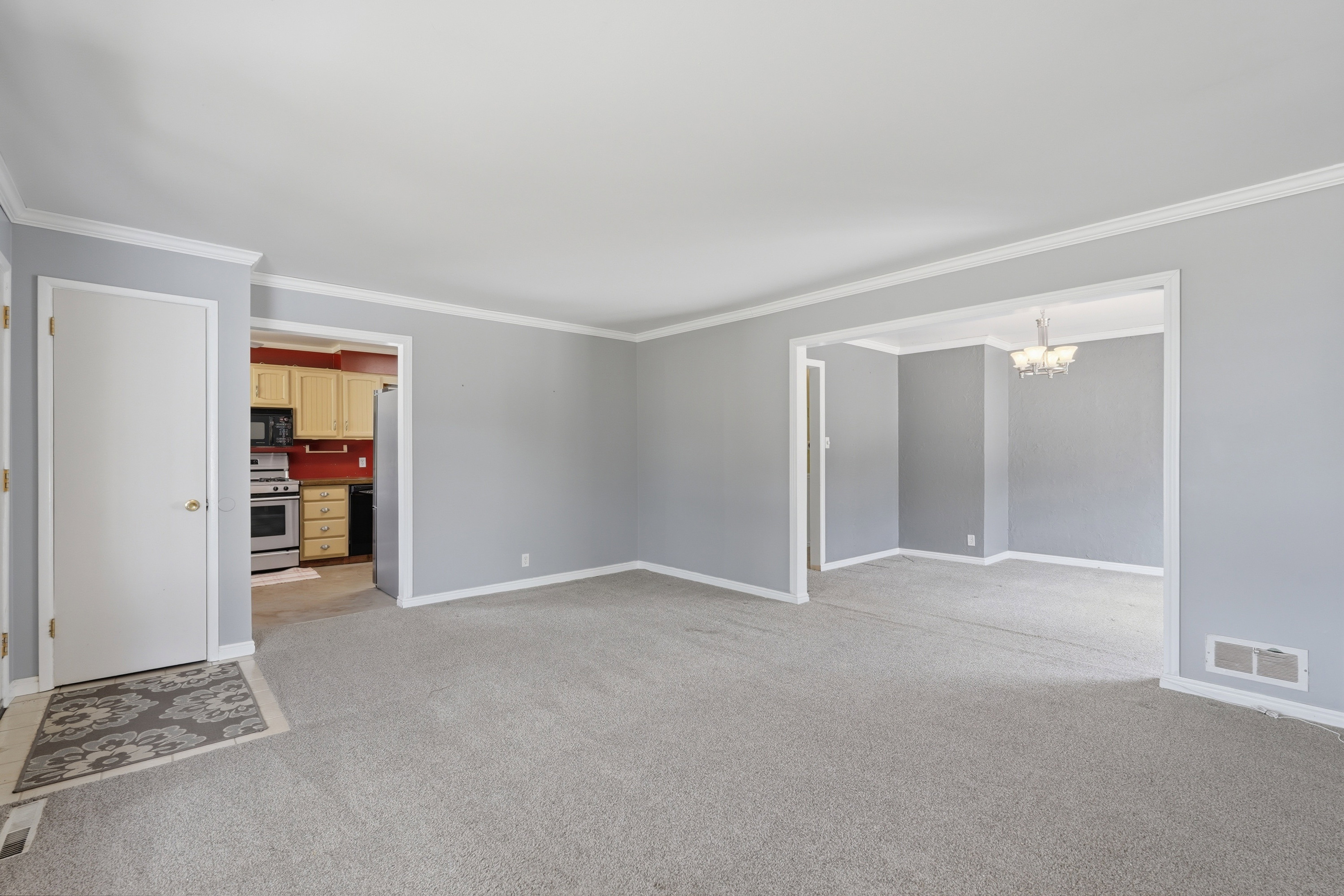 Light gray wall paint complemented by white crown molding and baseboards