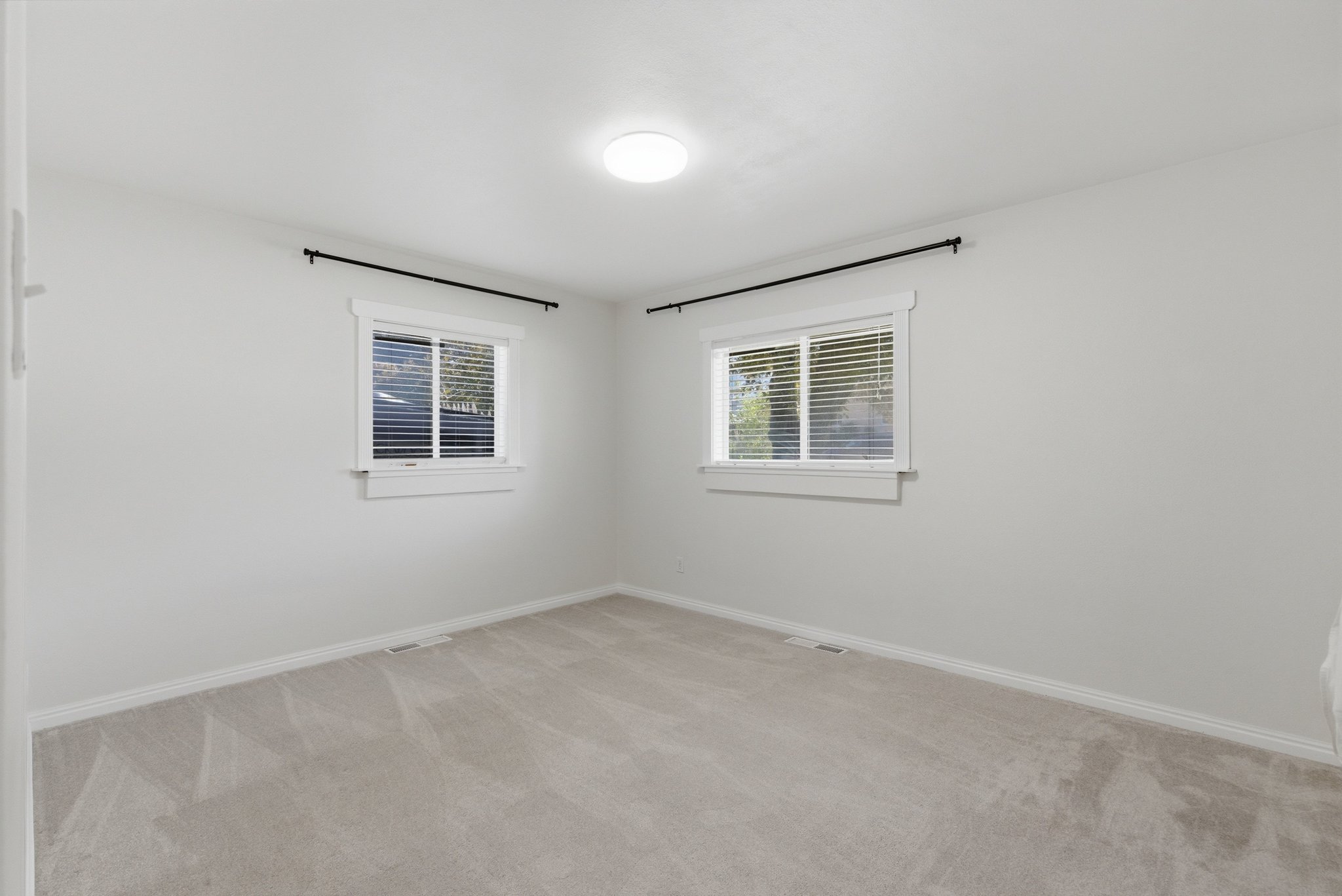 Neutral gray walls complement the light gray carpet flooring