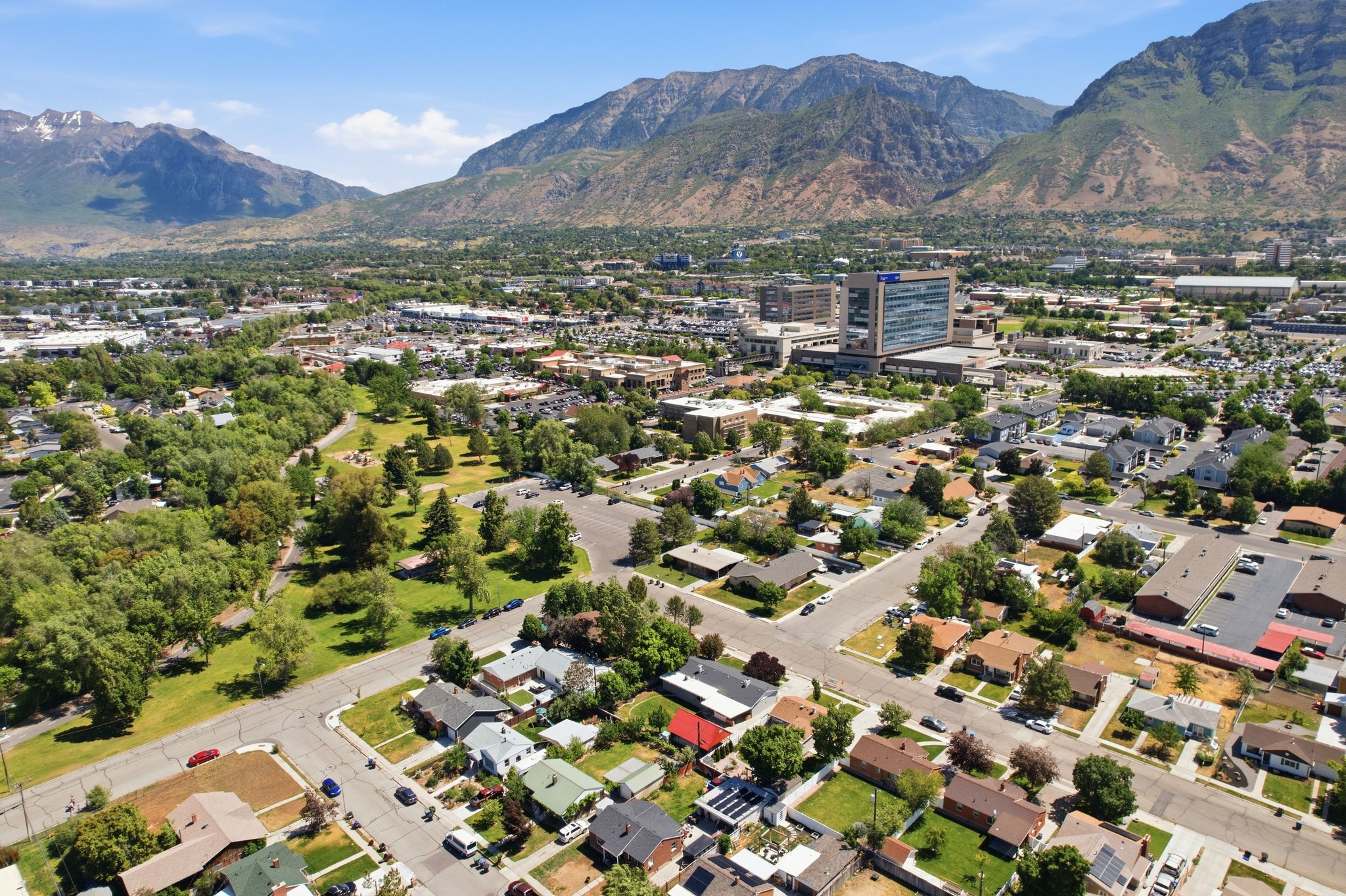 Aerial overview of a residential area featuring single-story homes with varied roofing materials