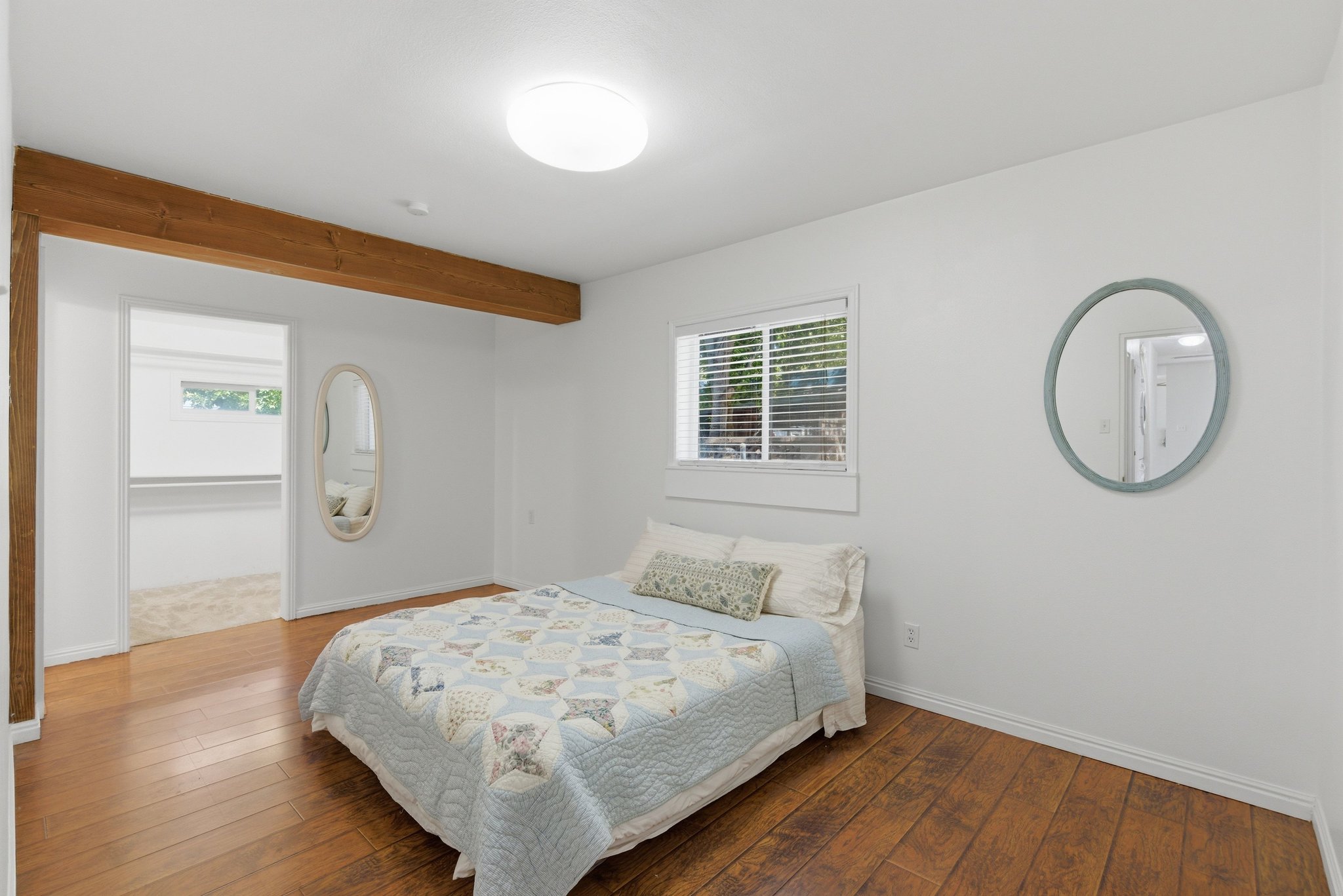 Bright room featuring wood-finish flooring and white baseboards