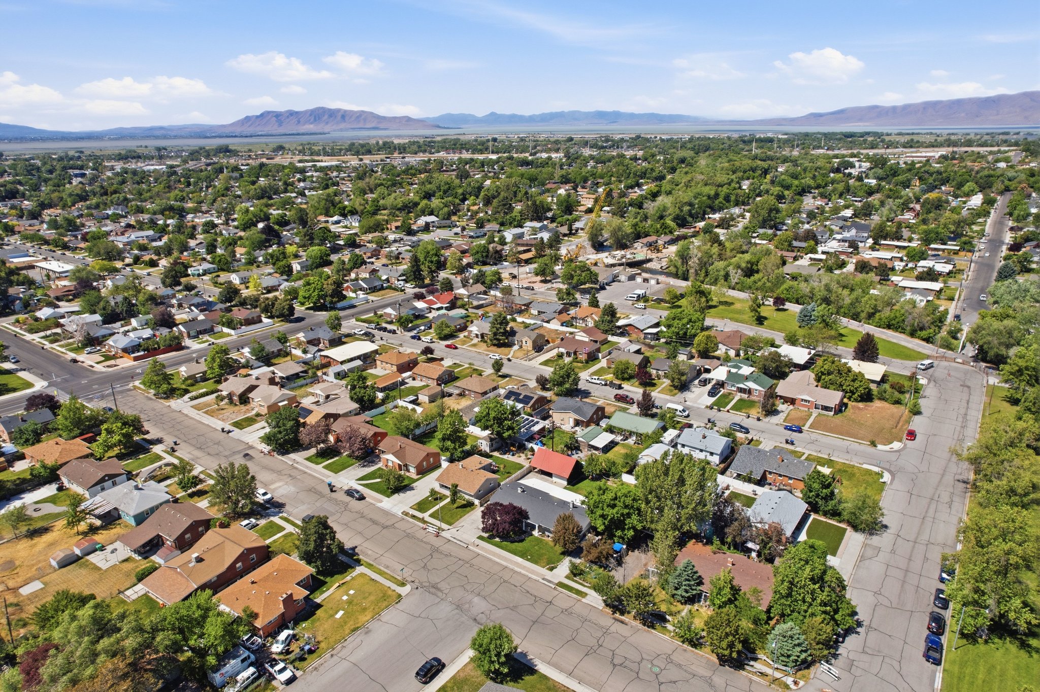 Expansive residential neighborhood featuring mature trees and paved streets