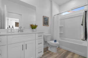 Bathroom featuring a vanity with white cabinetry, a white countertop, and a rectangular undermount sink