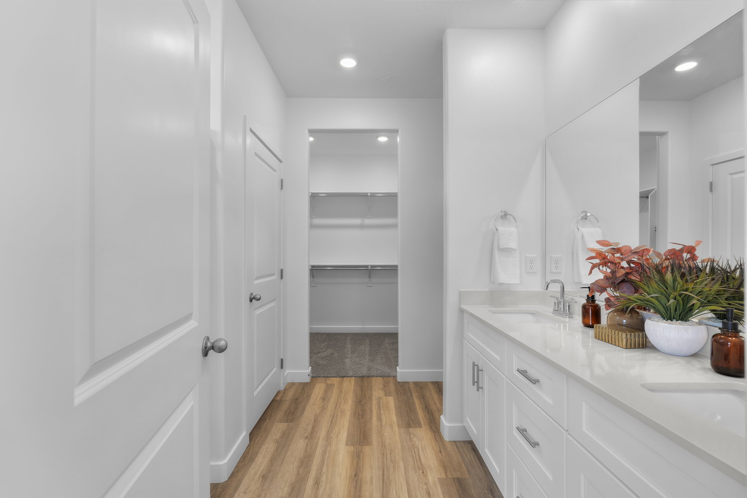 Dual vanity with integrated sinks, white cabinetry, and a light-toned countertop