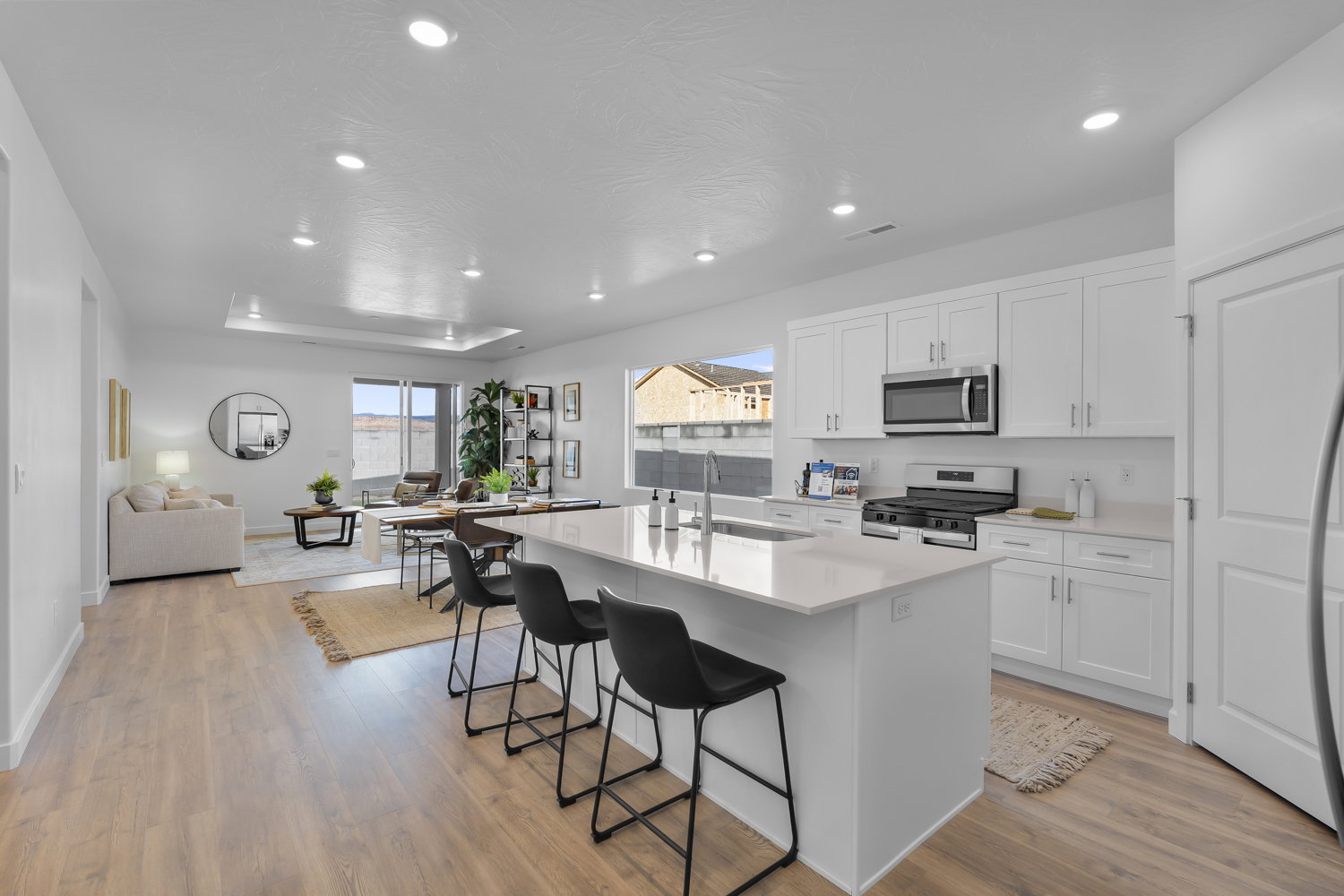 Open-concept kitchen and living area featuring wood-finish flooring
