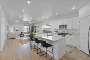 Open-concept kitchen and living area featuring wood-finish flooring