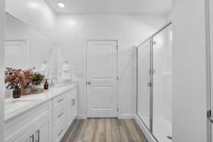 Bathroom featuring a dual vanity with white cabinetry, light-toned countertops, and dual undermount sinks