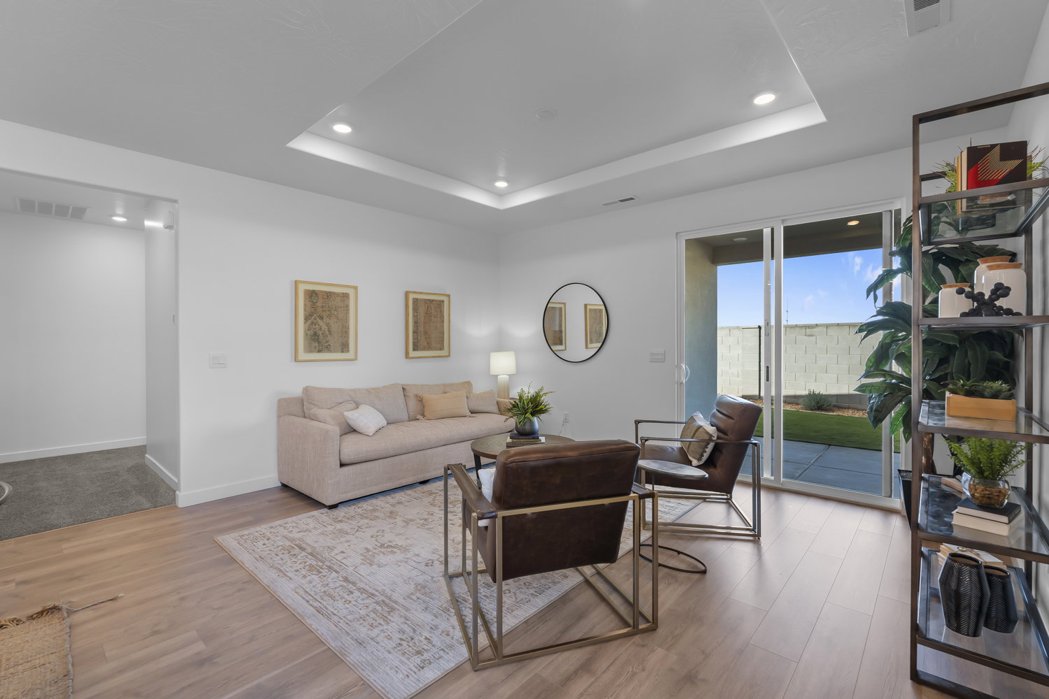 Living area featuring wood-finish flooring and a tray ceiling with recessed lighting
