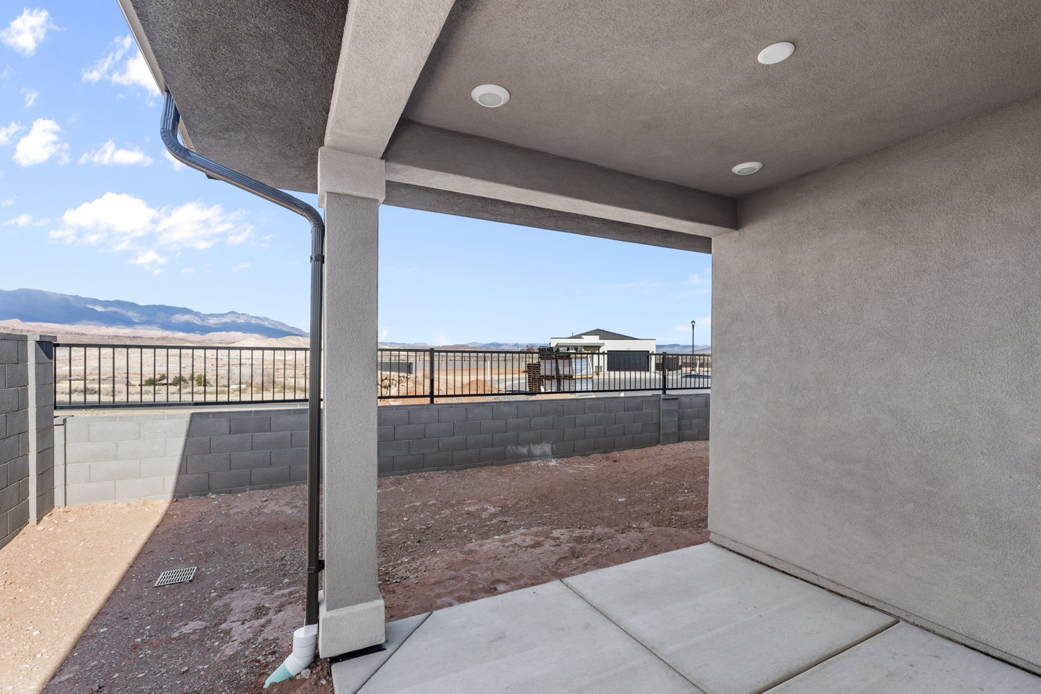 Covered patio with concrete flooring, recessed lighting, and a stucco finish