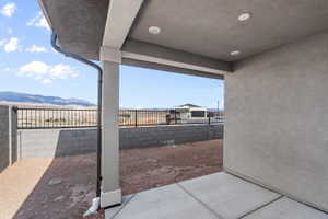 Covered patio with concrete flooring, recessed lighting, and a stucco finish