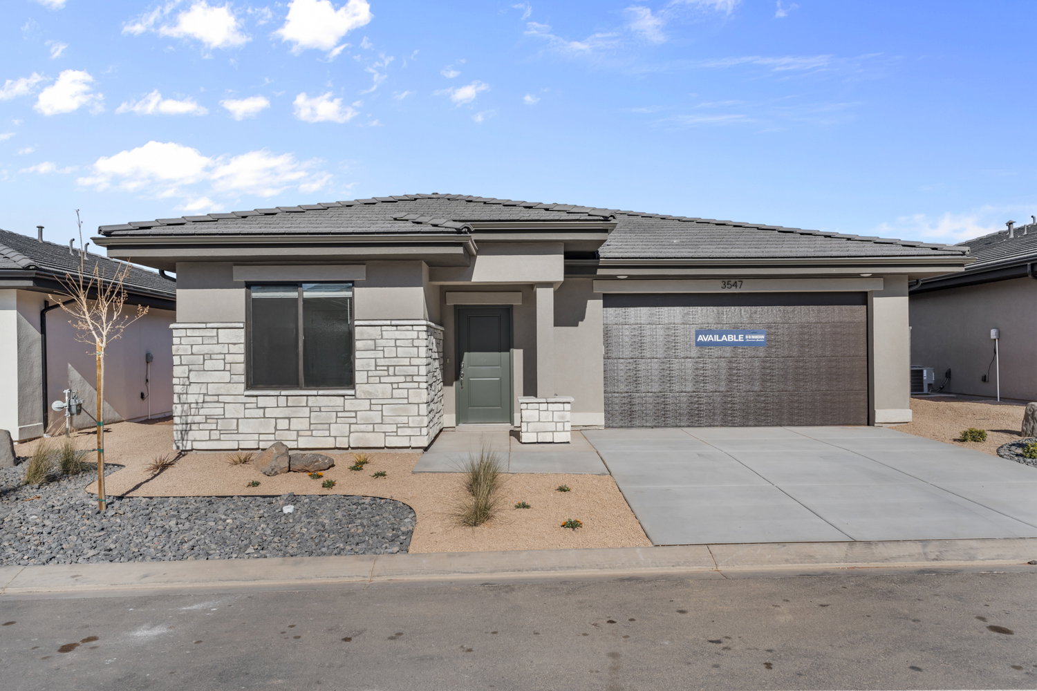 Modern single-story residence with a stucco and stone veneer facade