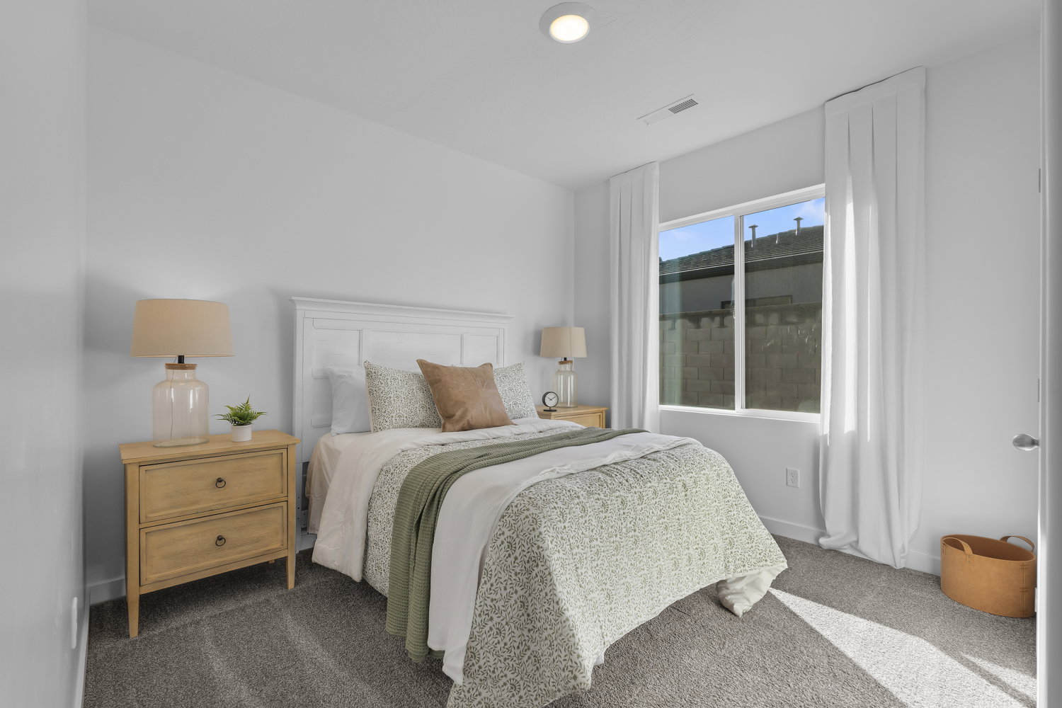 Neutral gray carpeting complements the bright white walls and trim