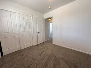 Neutral-toned carpeting extends throughout the room, complemented by white walls and trim