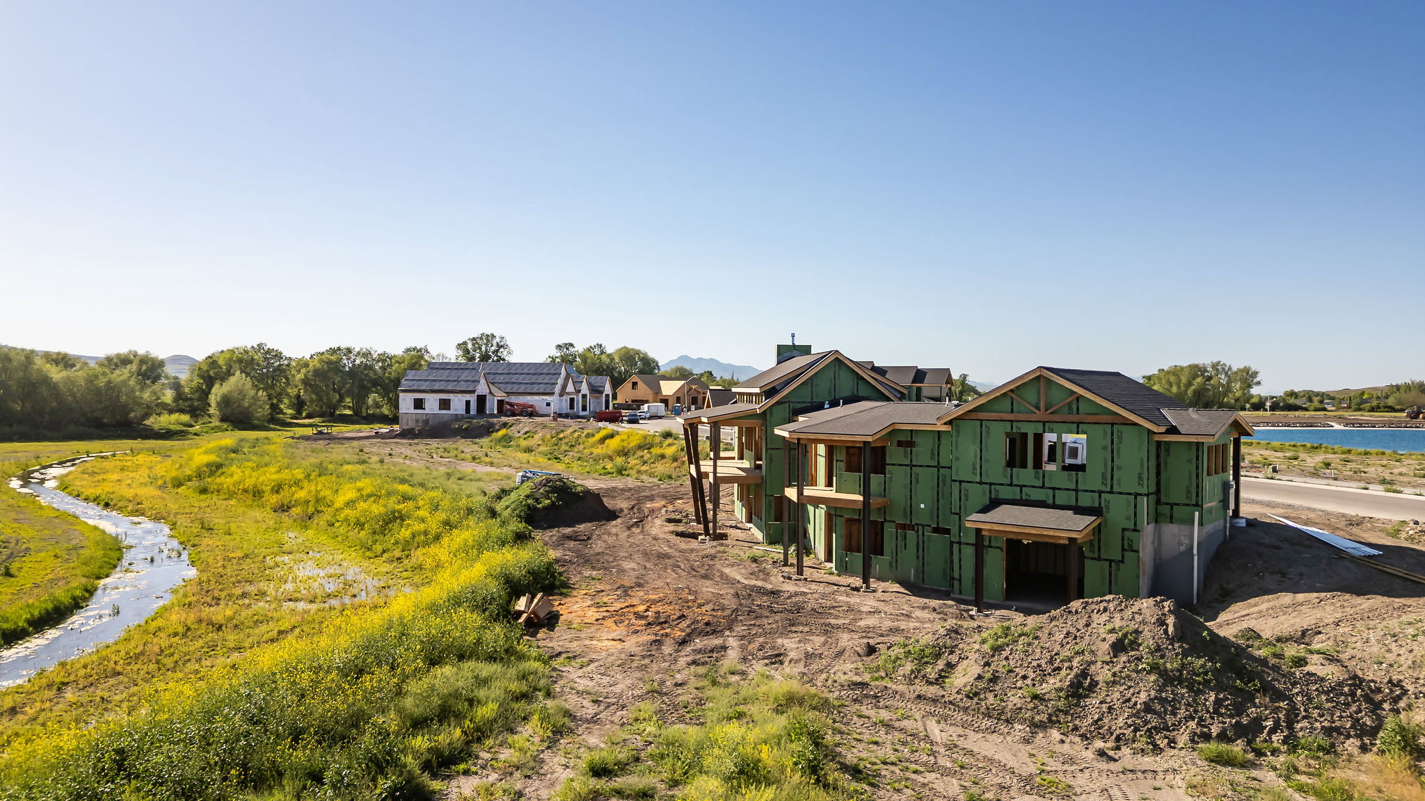 New construction property featuring a two-story design with prominent gables and a dark shingle roof