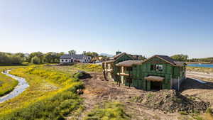 New construction property featuring a two-story design with prominent gables and a dark shingle roof