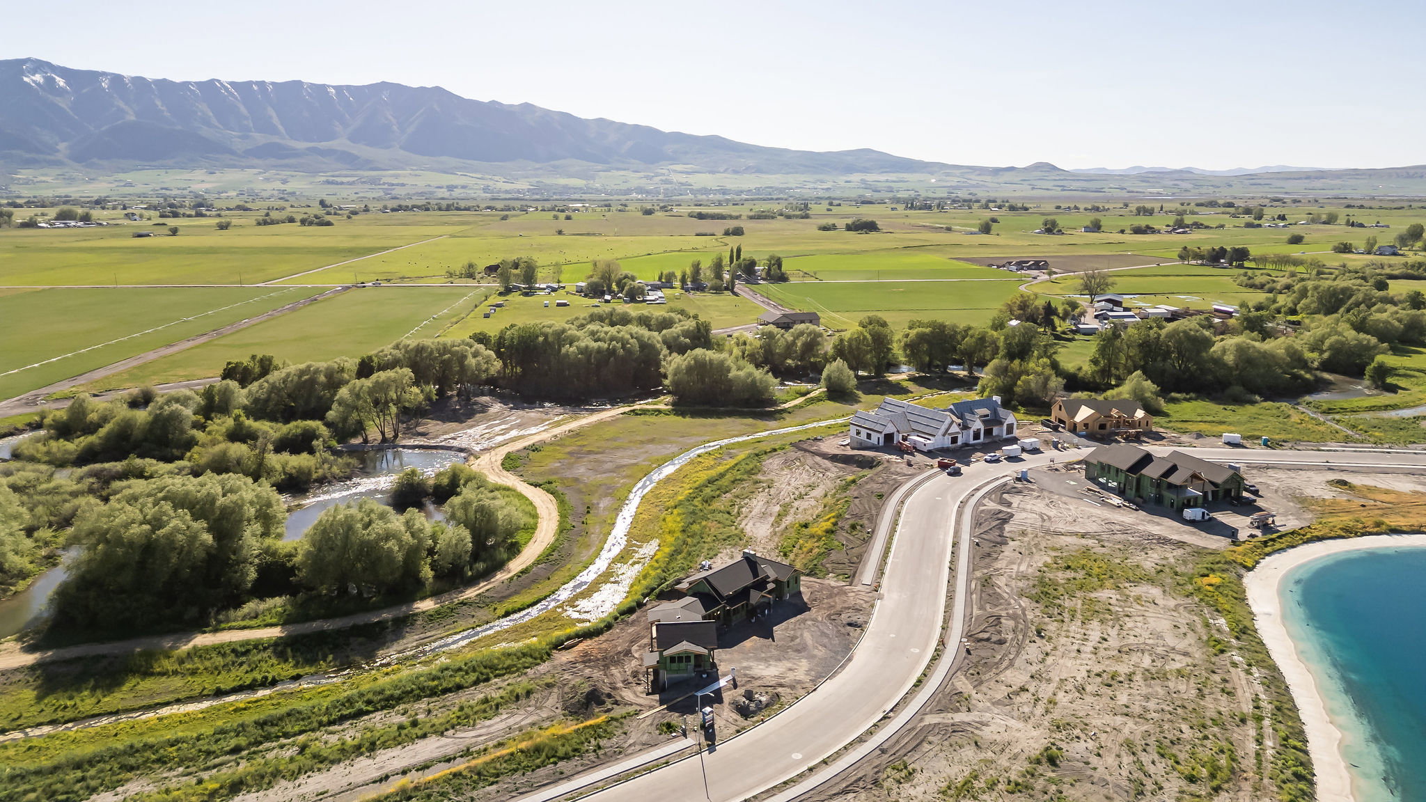 Expansive rural landscape featuring distant mountains and verdant fields