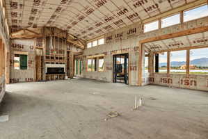 Spacious open-concept interior featuring vaulted ceilings and abundant natural light